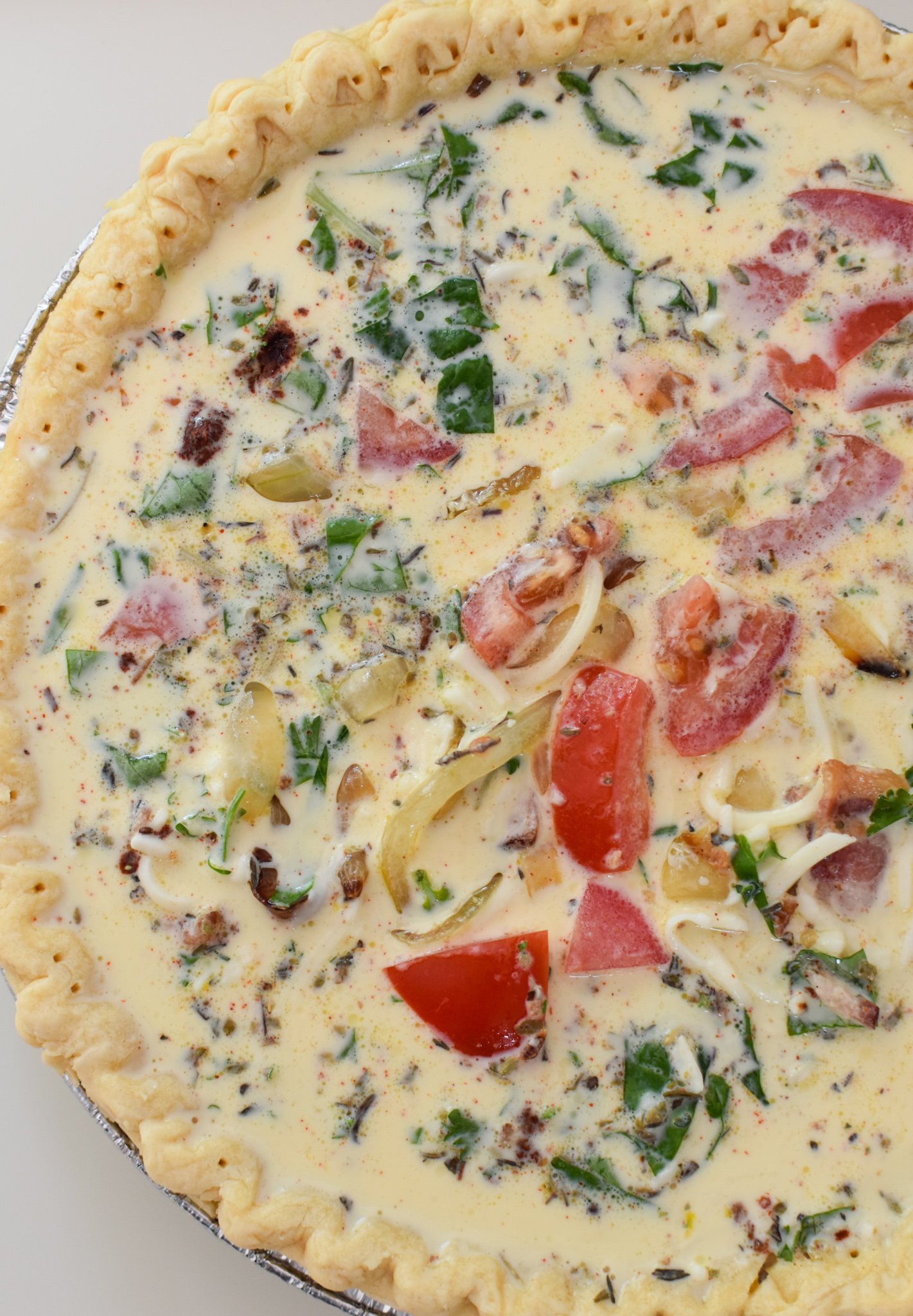 Caprese Quiche Lorraine Recipe egg mixture in pie crust.