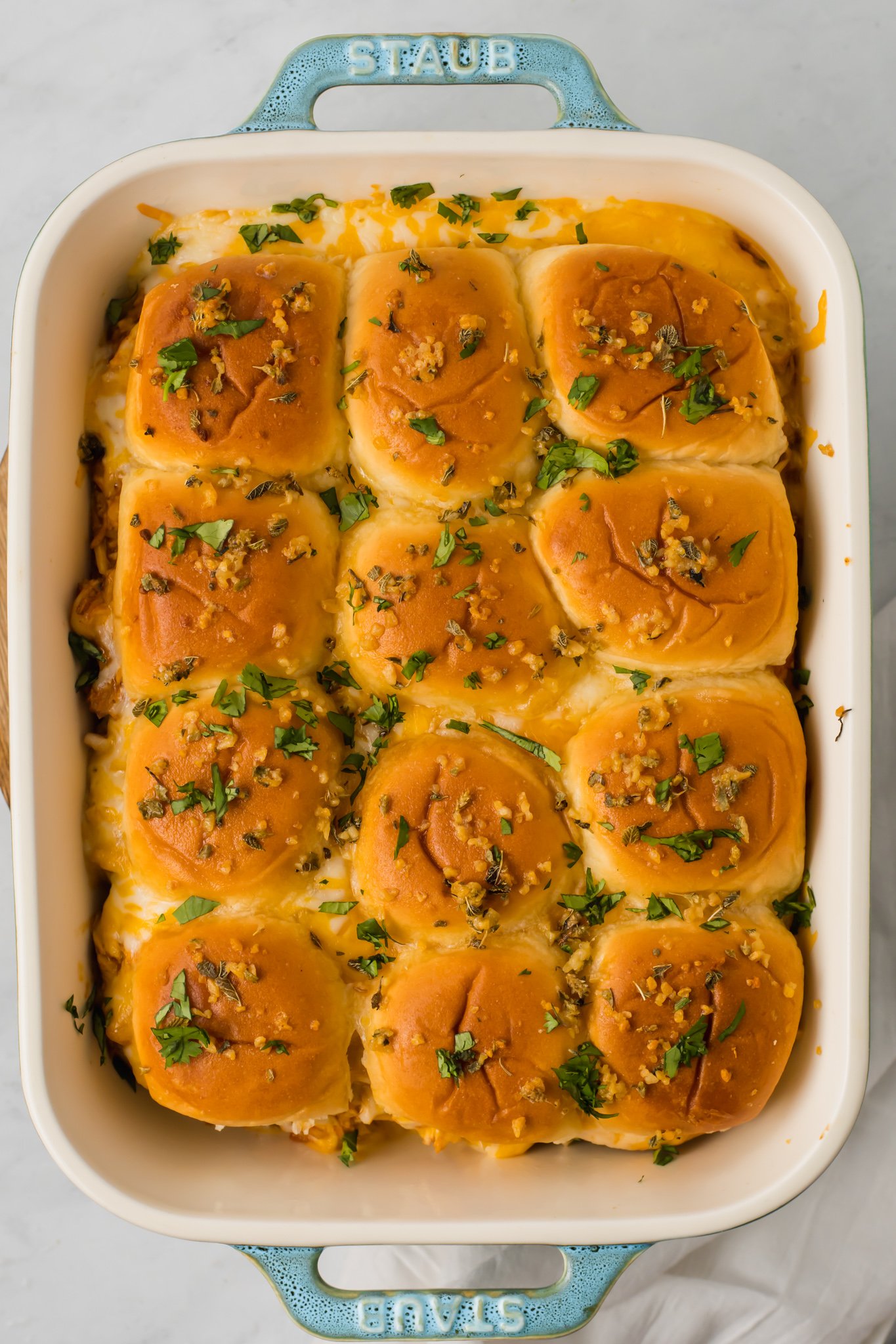Chicken Enchilada Sliders with herbs on top.