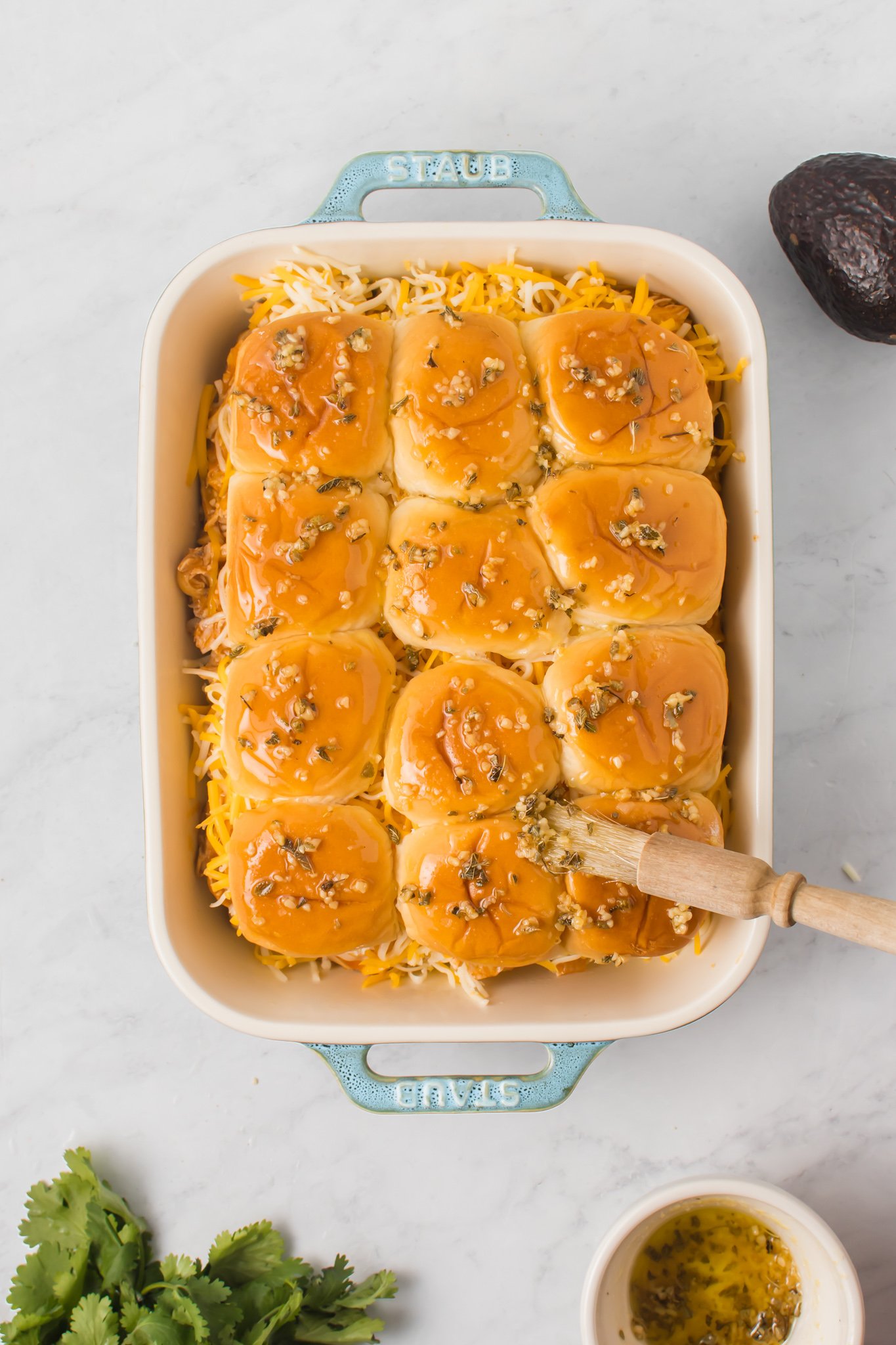 Chicken Enchilada Sliders with herbs on top.