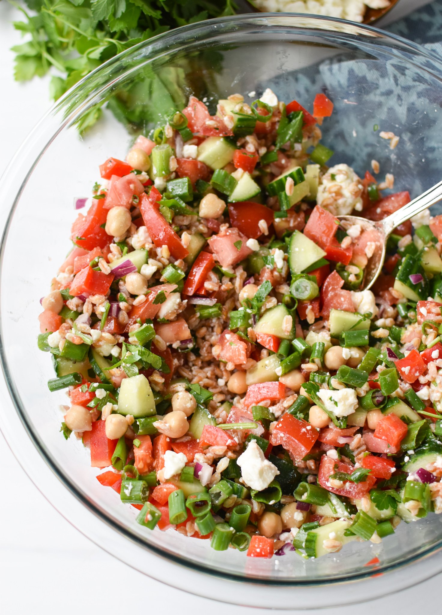 Mediterranean Farro Salad in a clear bowl.