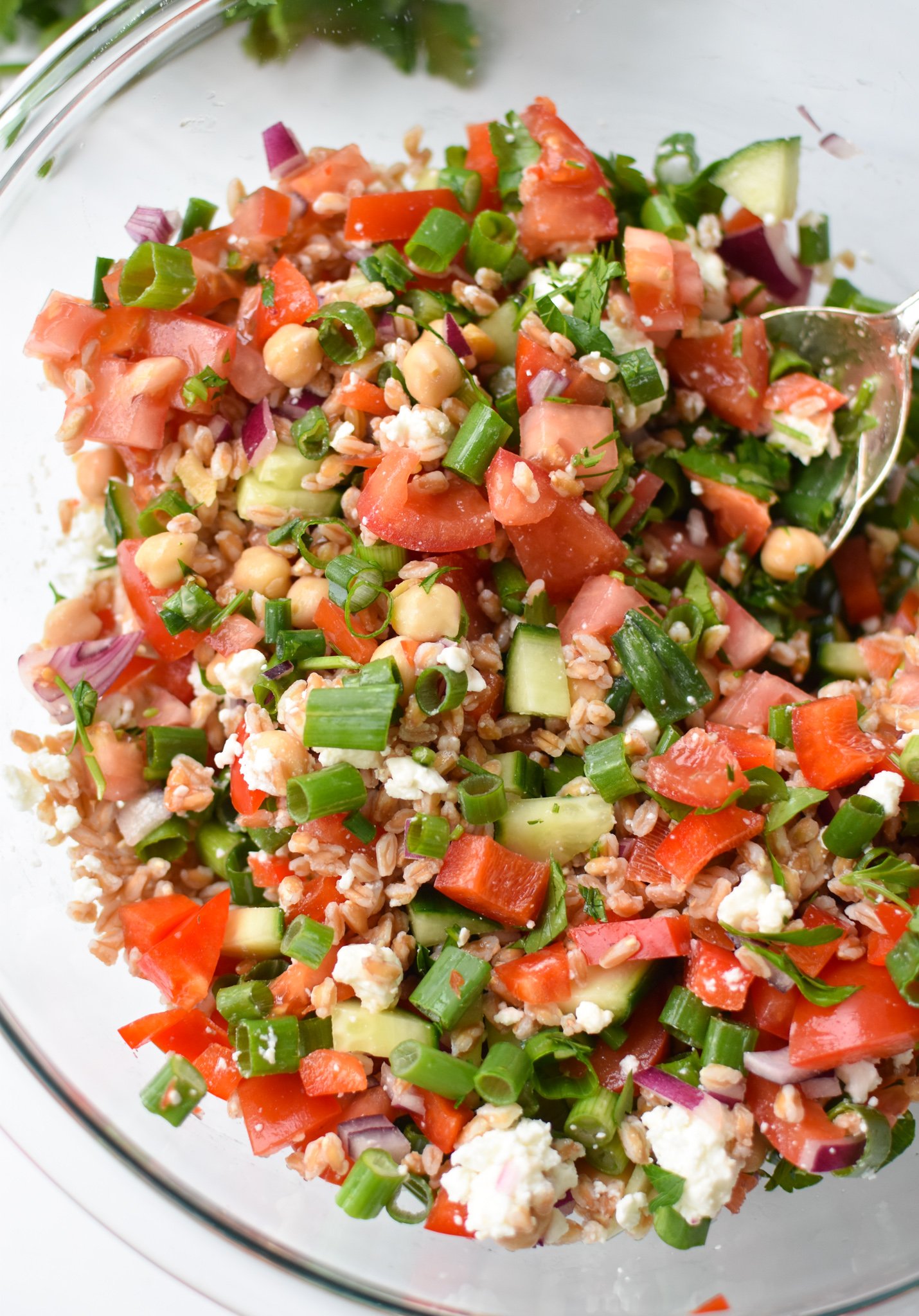 Mediterranean Farro Salad in a clear bowl. 