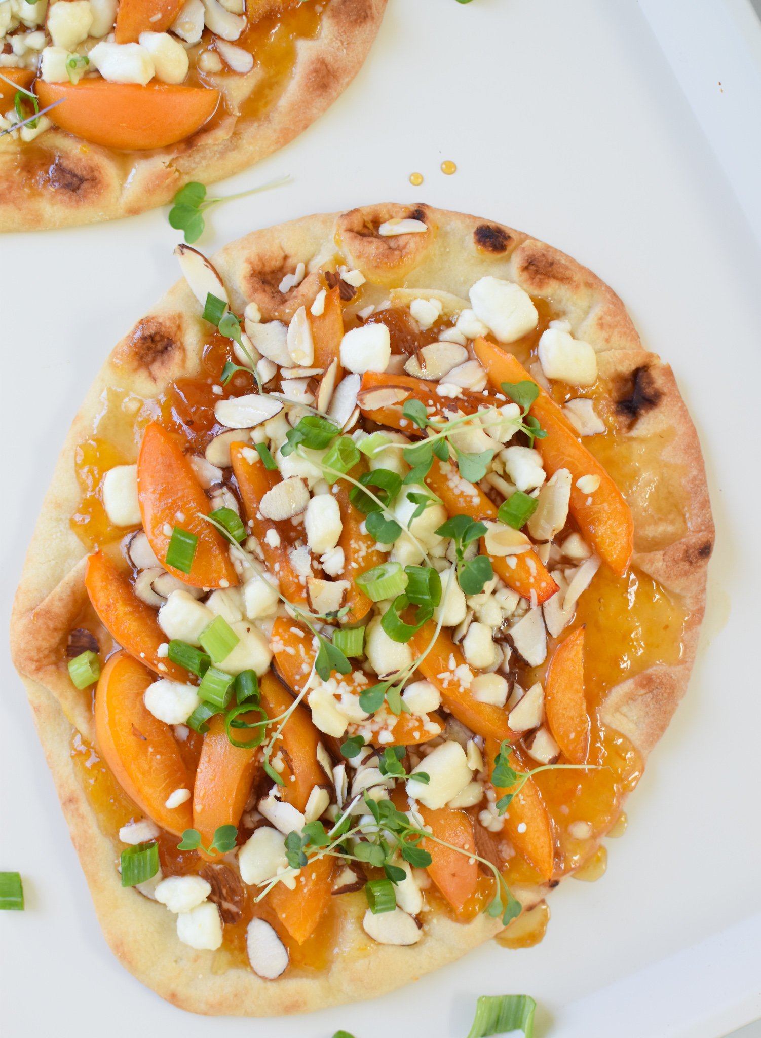 Goat Cheese Apricot Pizza on a white plate. 