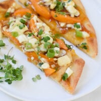 Goat Cheese Apricot Pizza cut on a plate.