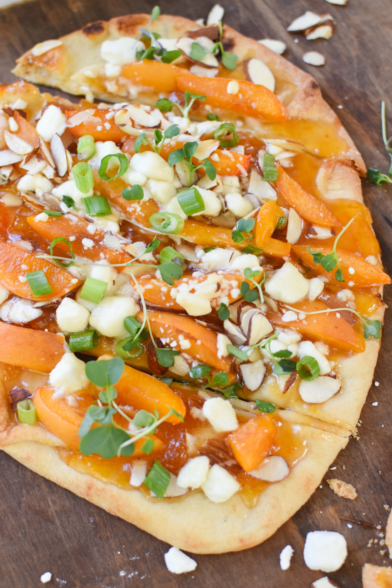 Goat Cheese Apricot Pizza on a cutting board. 