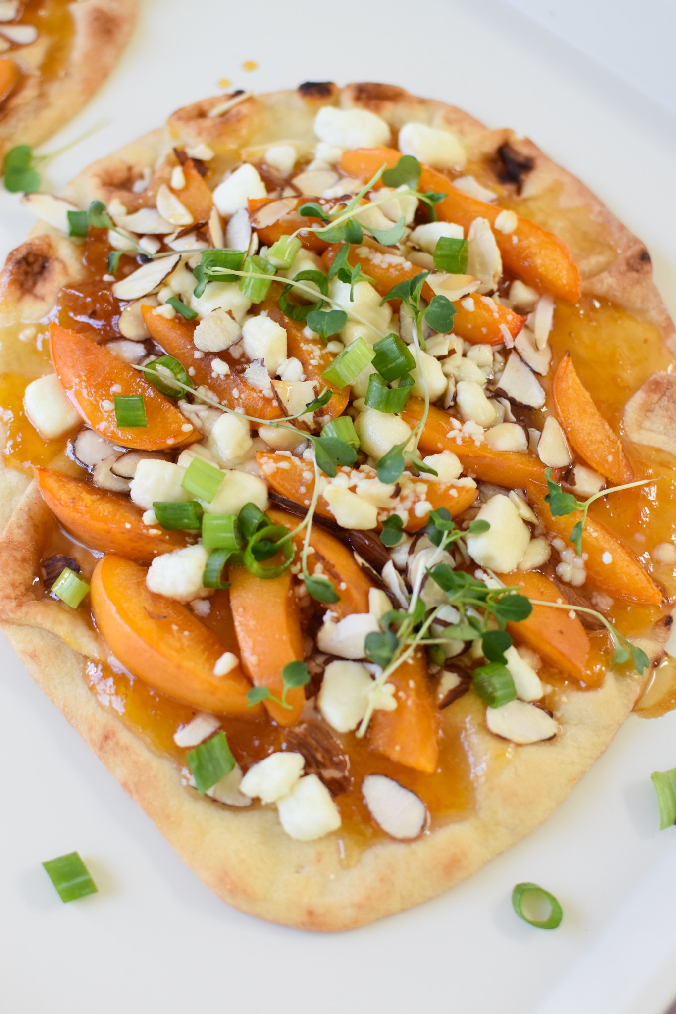 Goat Cheese Apricot Pizza on a white plate. 