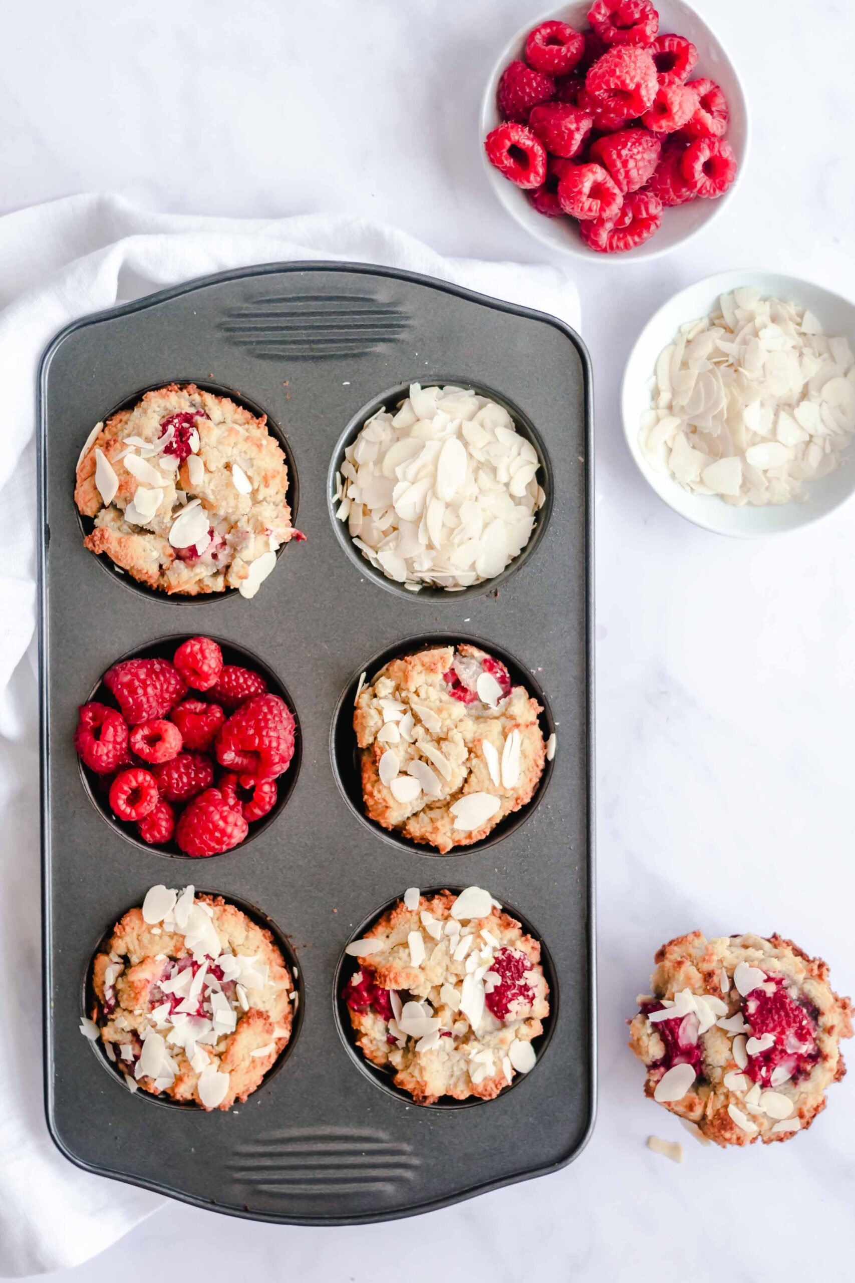 Keto Raspberry Muffins in a muffin tin. 