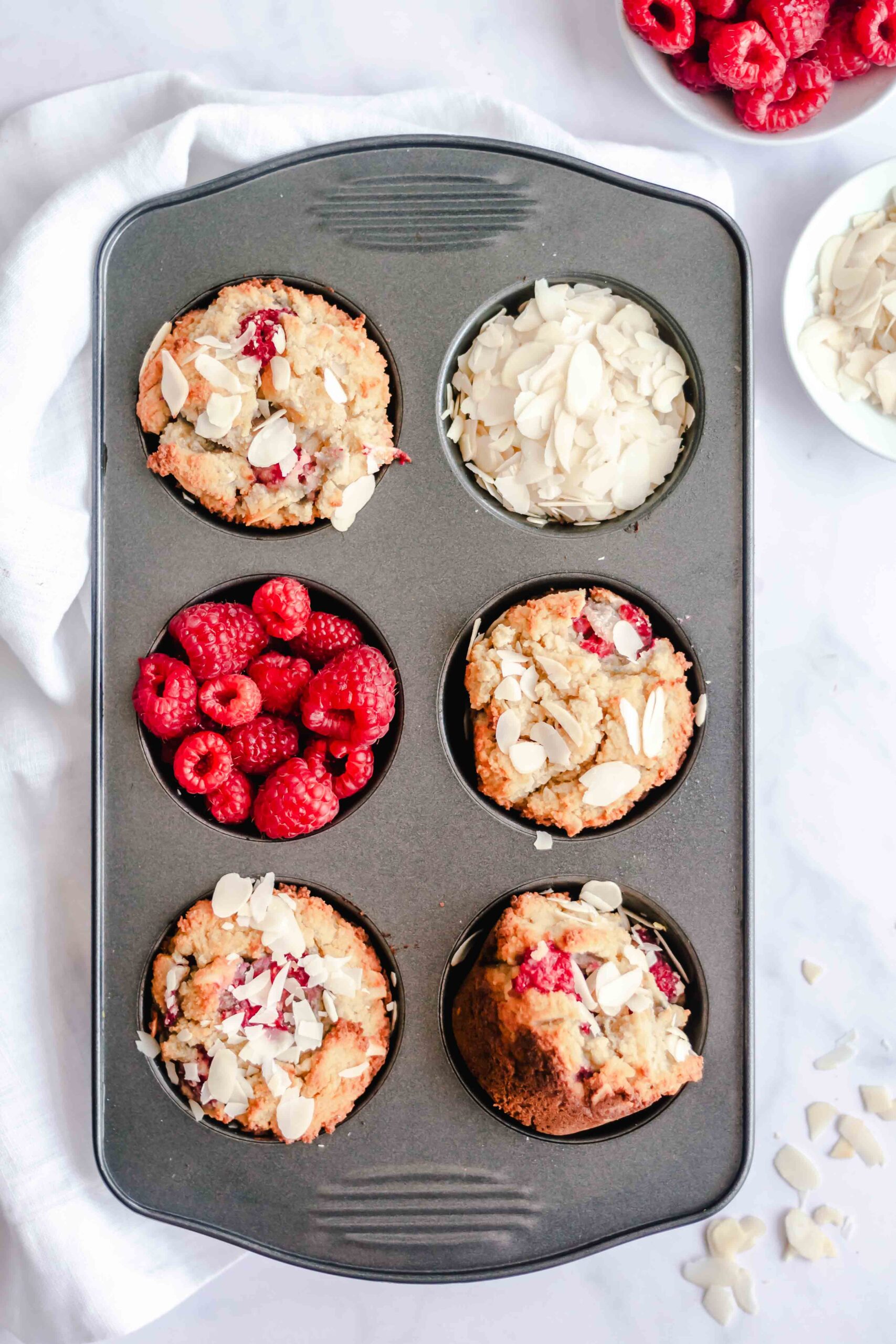Keto Raspberry Muffins in a muffin tin. 