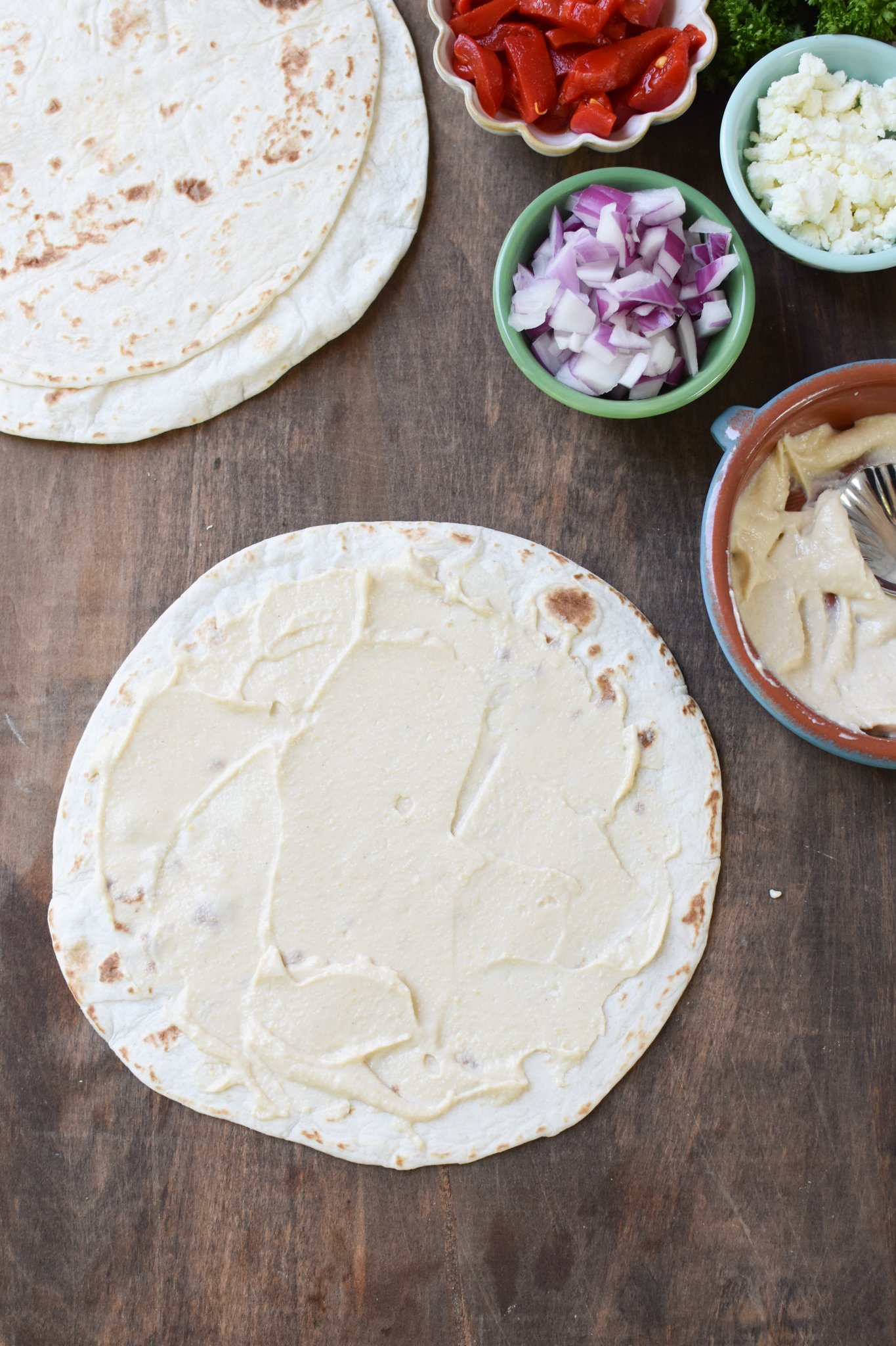 Mediterranean Pinwheels hummus on a tortilla.
