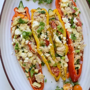 Mediterranean Tuna Couscous Stuffed Peppers on a white platter.