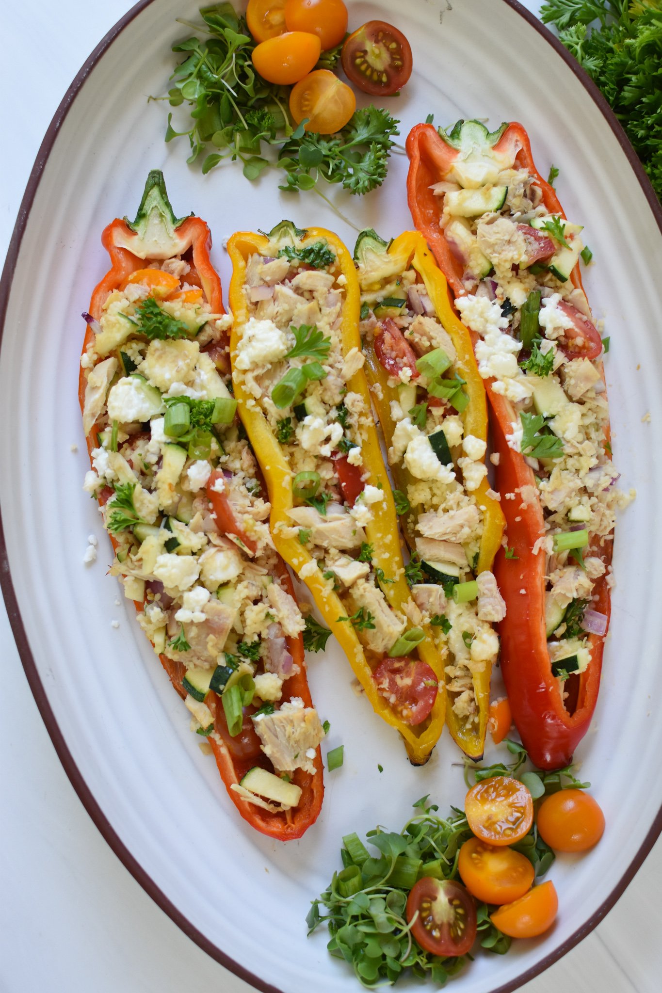 Mediterranean Tuna Couscous Stuffed Peppers on a white platter.