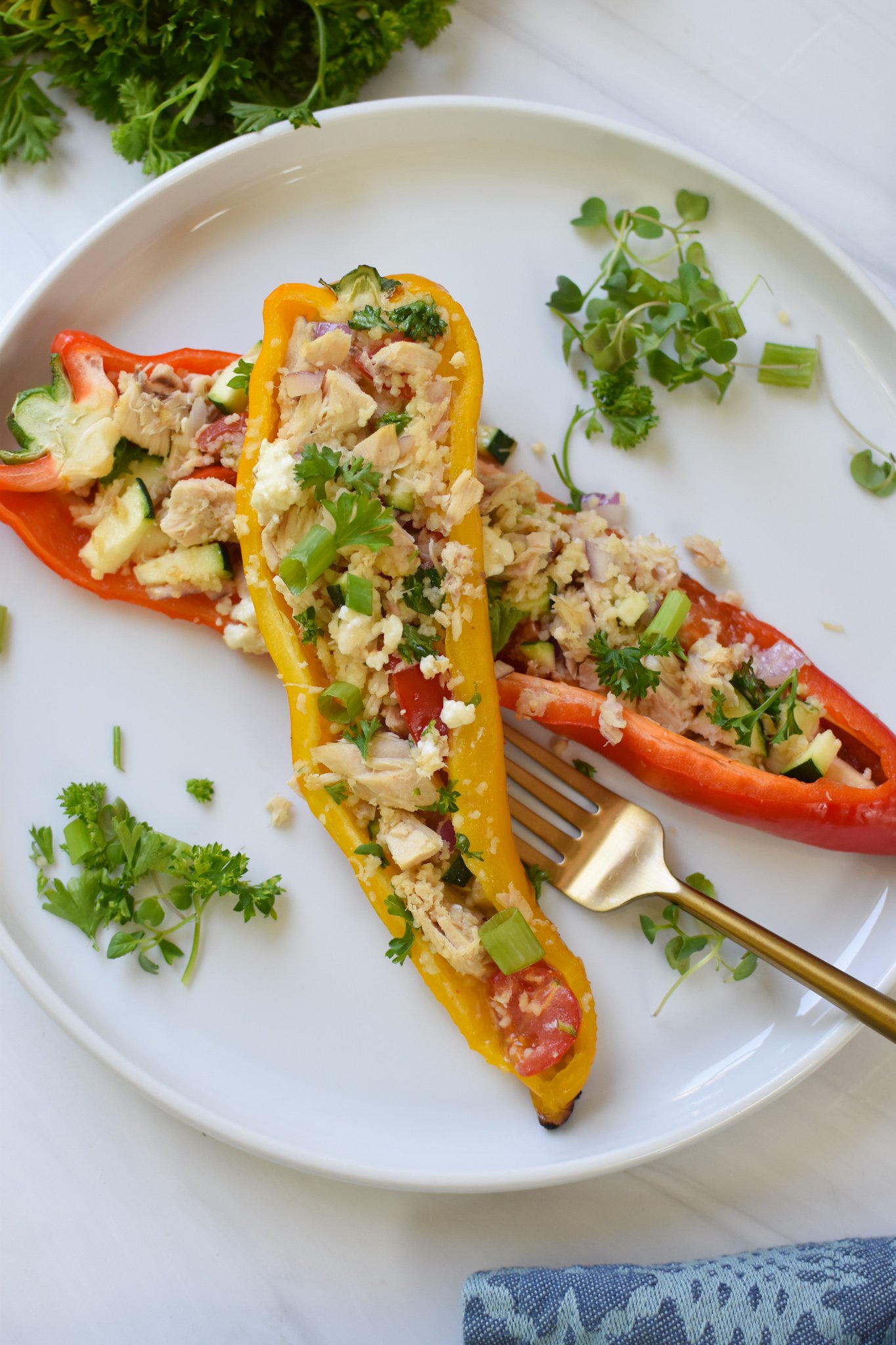Mediterranean Tuna Couscous Stuffed Peppers with a gold fork.
