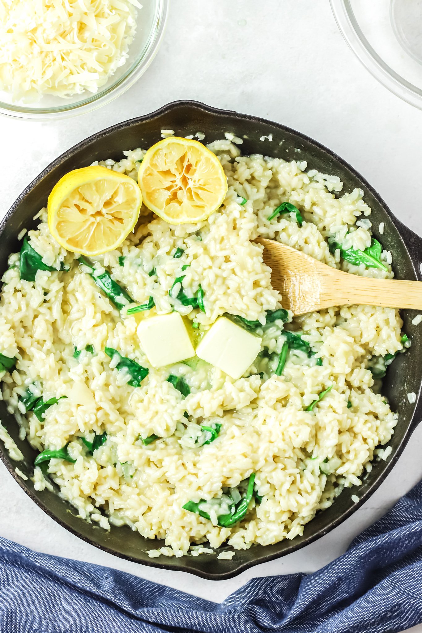 Oven Baked Chicken Thighs with Risotto in a skillet with lemons. 