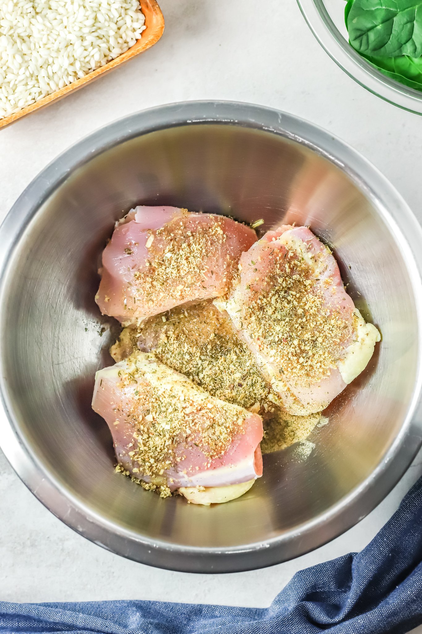 Oven Baked Chicken Thighs with Risotto chicken with seasonings. 