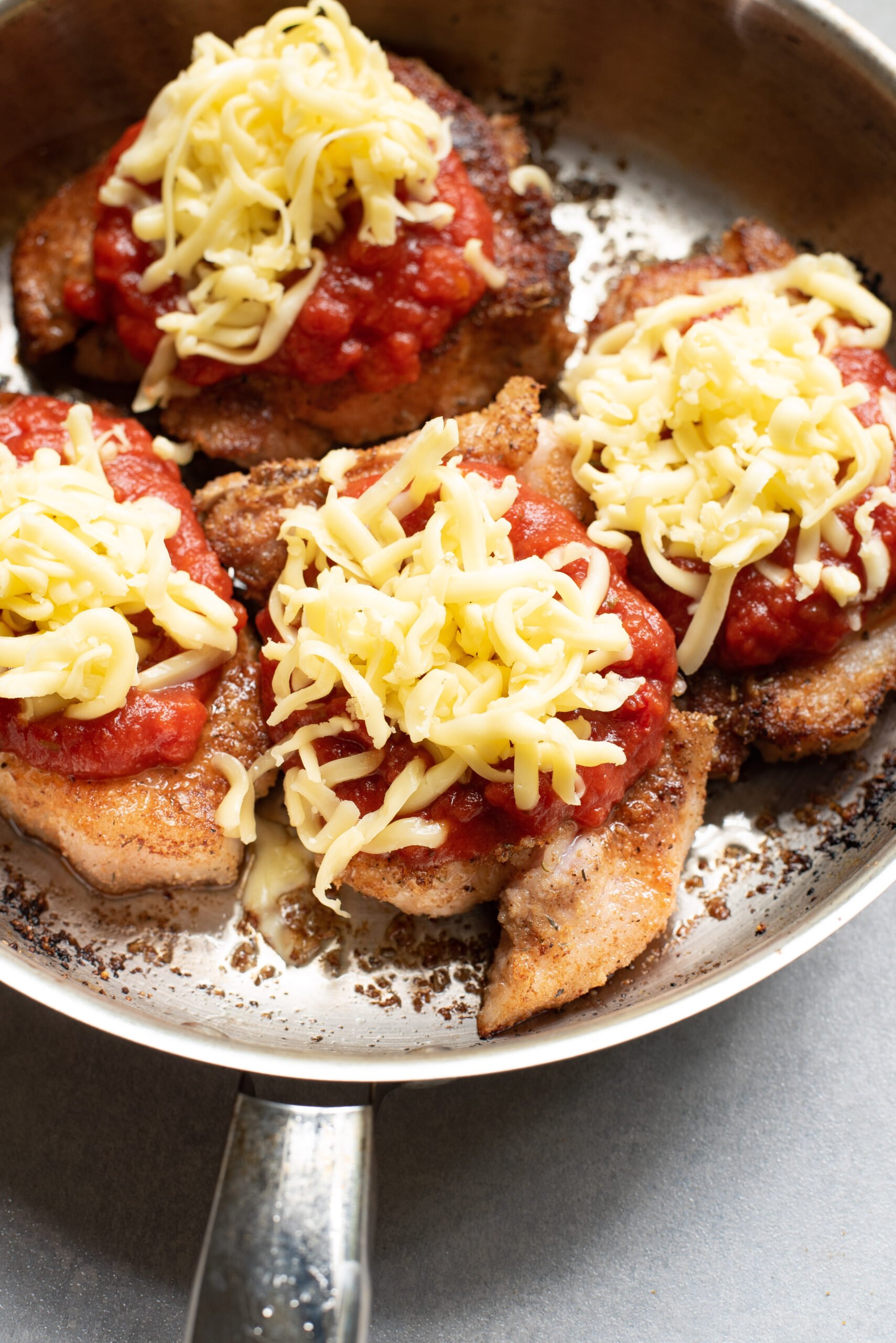 Parmesan Crusted Pork Chops with shredded cheese. 
