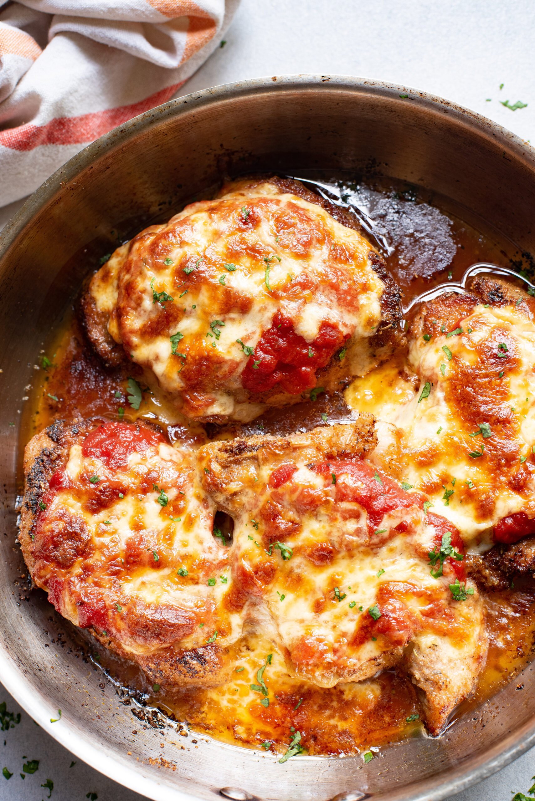 Parmesan Crusted Pork Chops with cheese and sauce. 