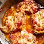 Parmesan Crusted Pork Chops in a skillet with cheese.