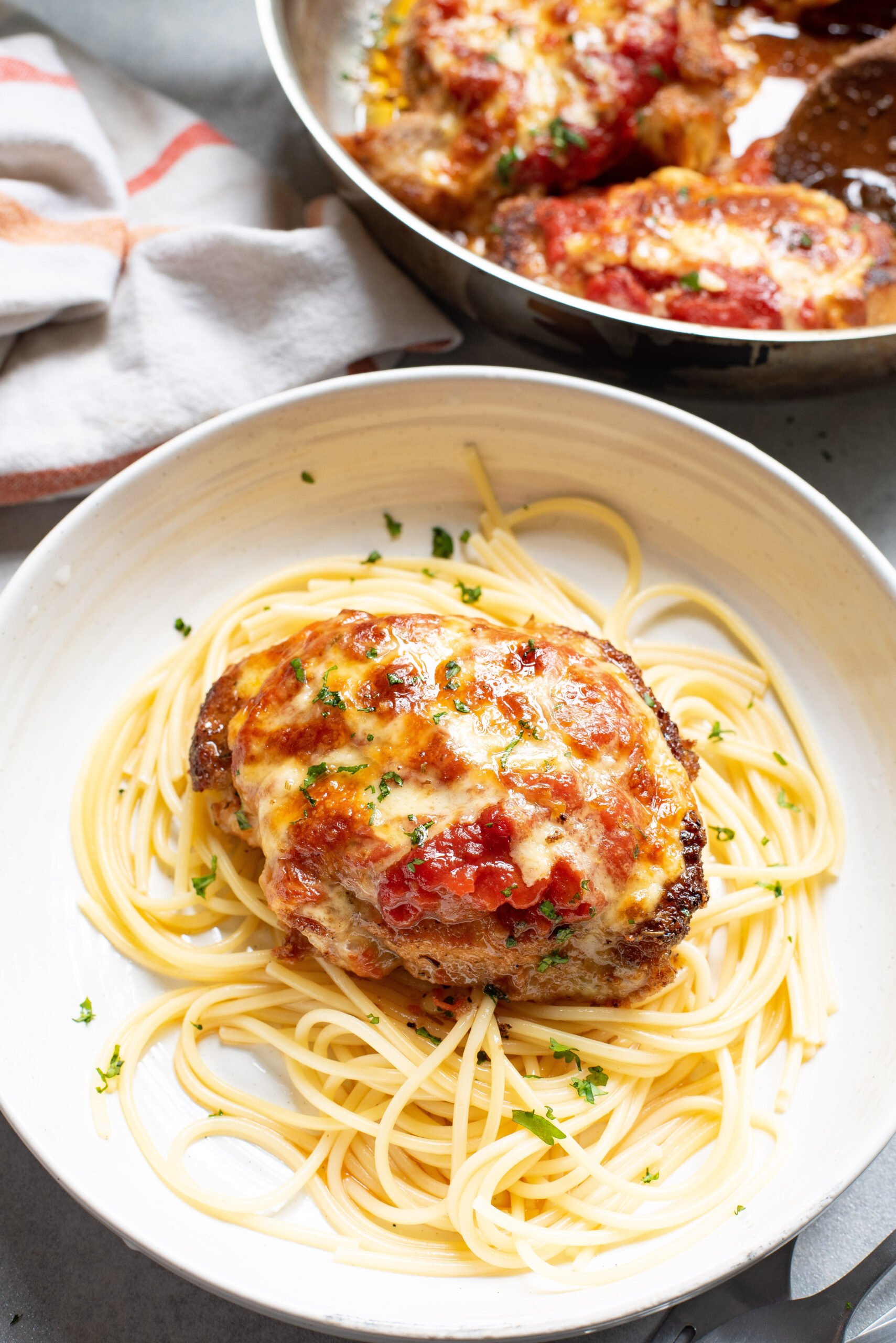 Parmesan Crusted Pork Chops in a skillet.