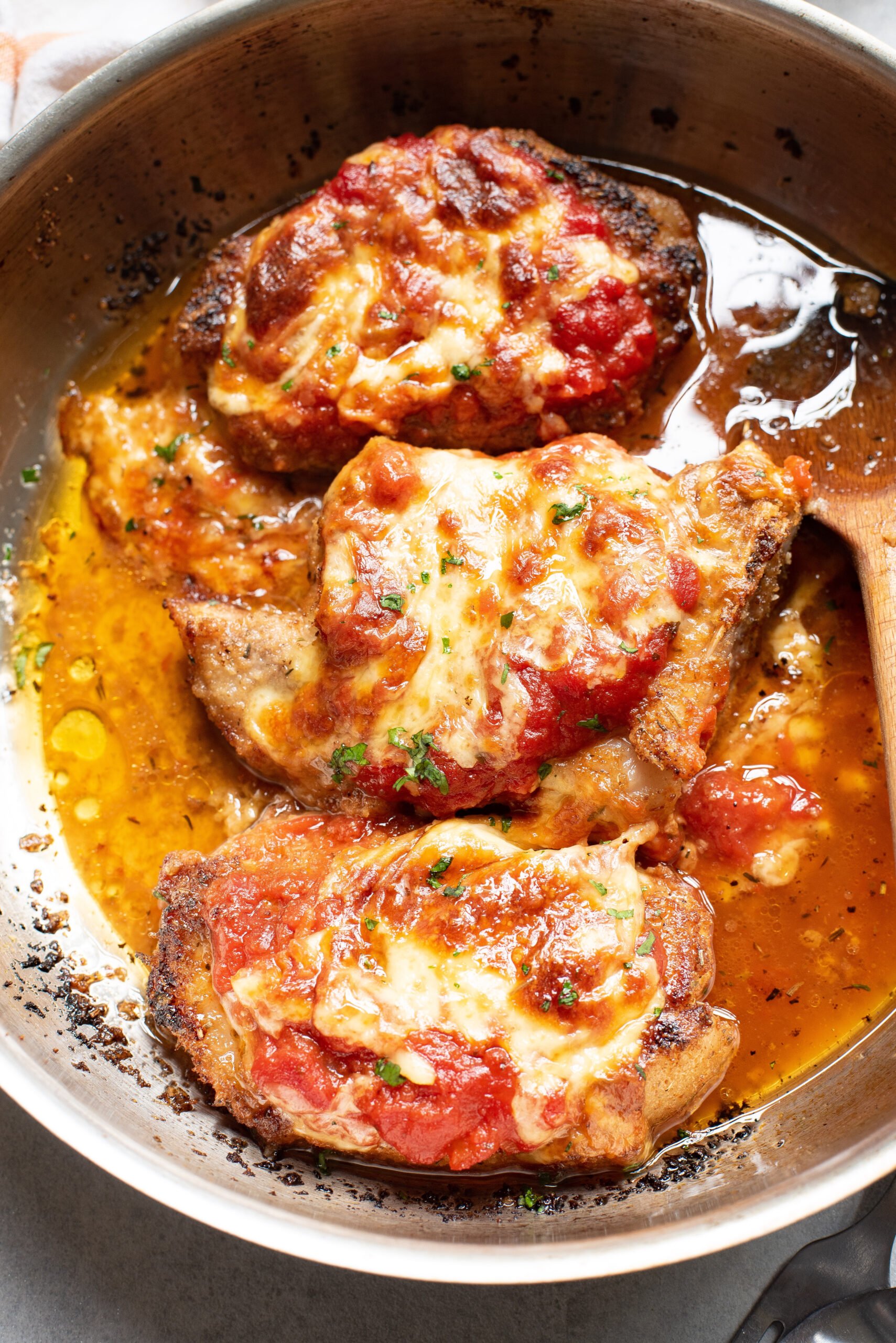 Parmesan Crusted Pork Chops in a skillet. 