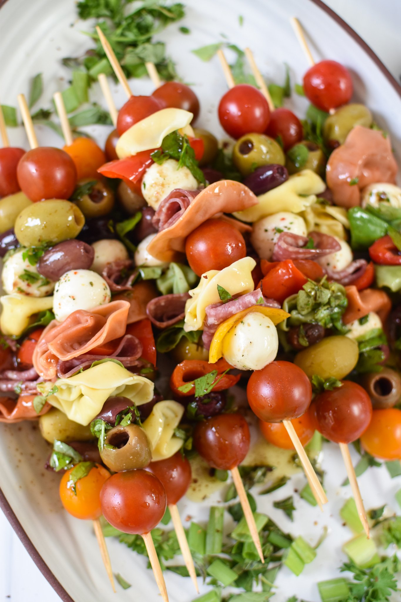 Antipasto Skewers on a white platter.