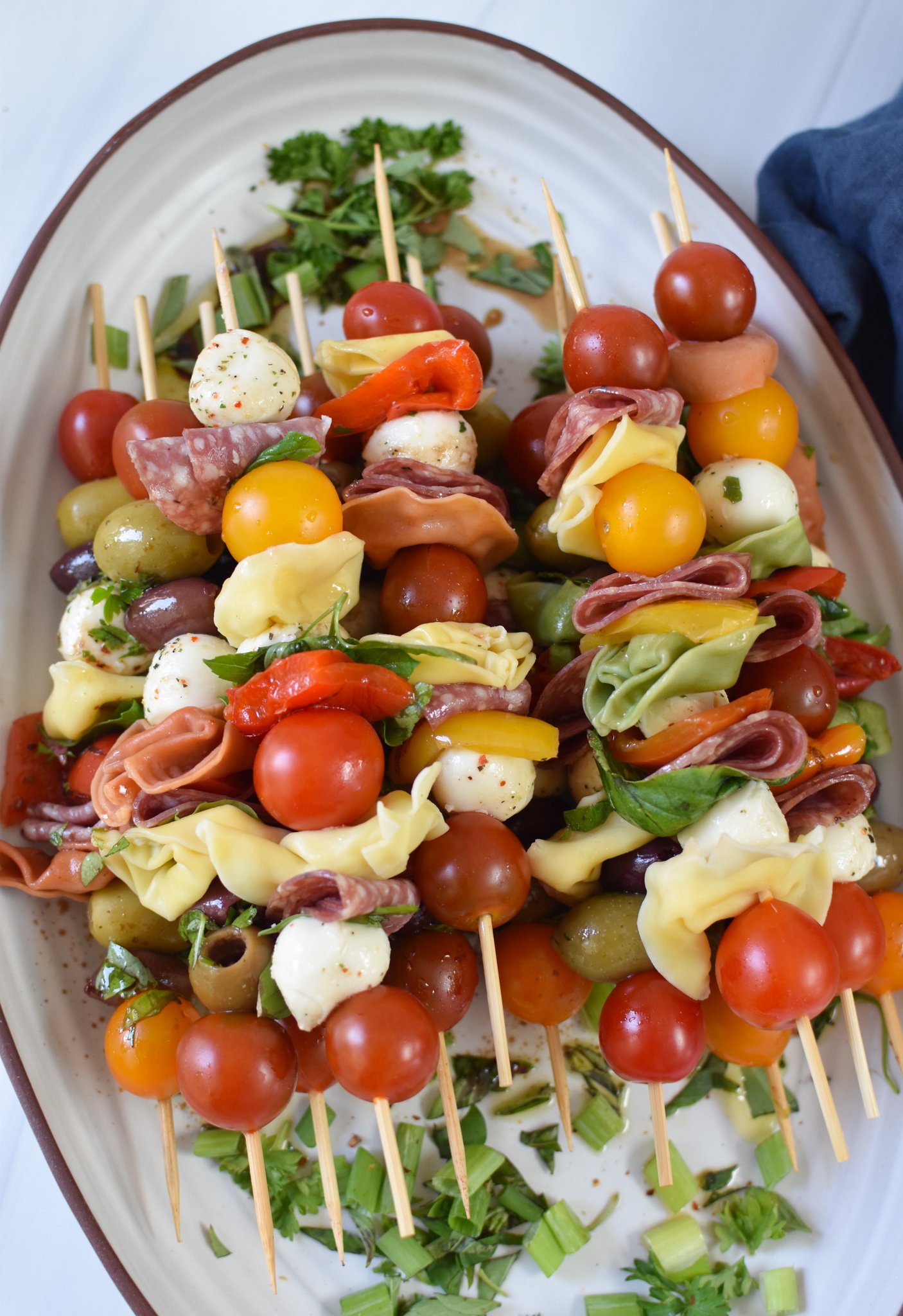 Antipasto Skewers on a white platter.