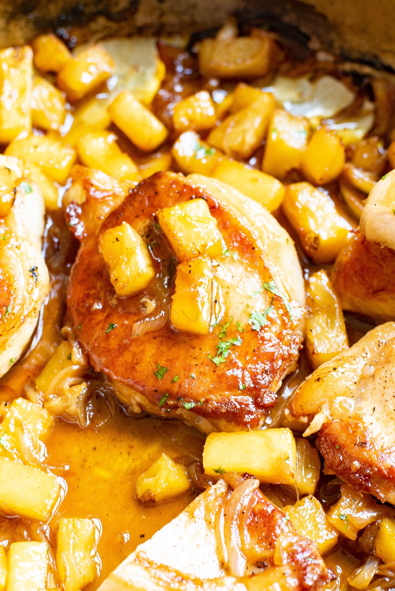 Easy pineapple pork chops up close in skillet. 
