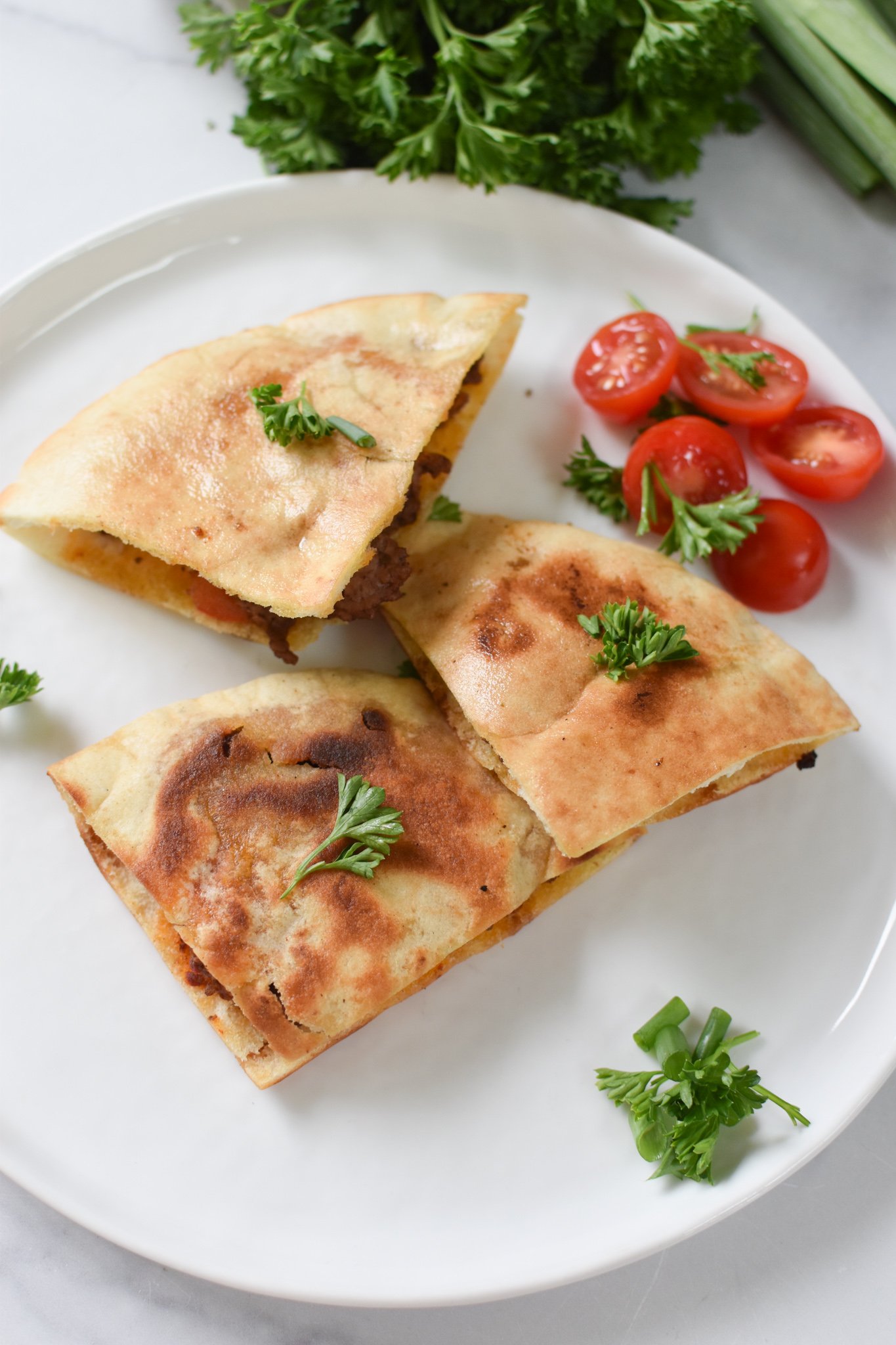 Lebanese Meat Stuffed Pitas on a white plater.