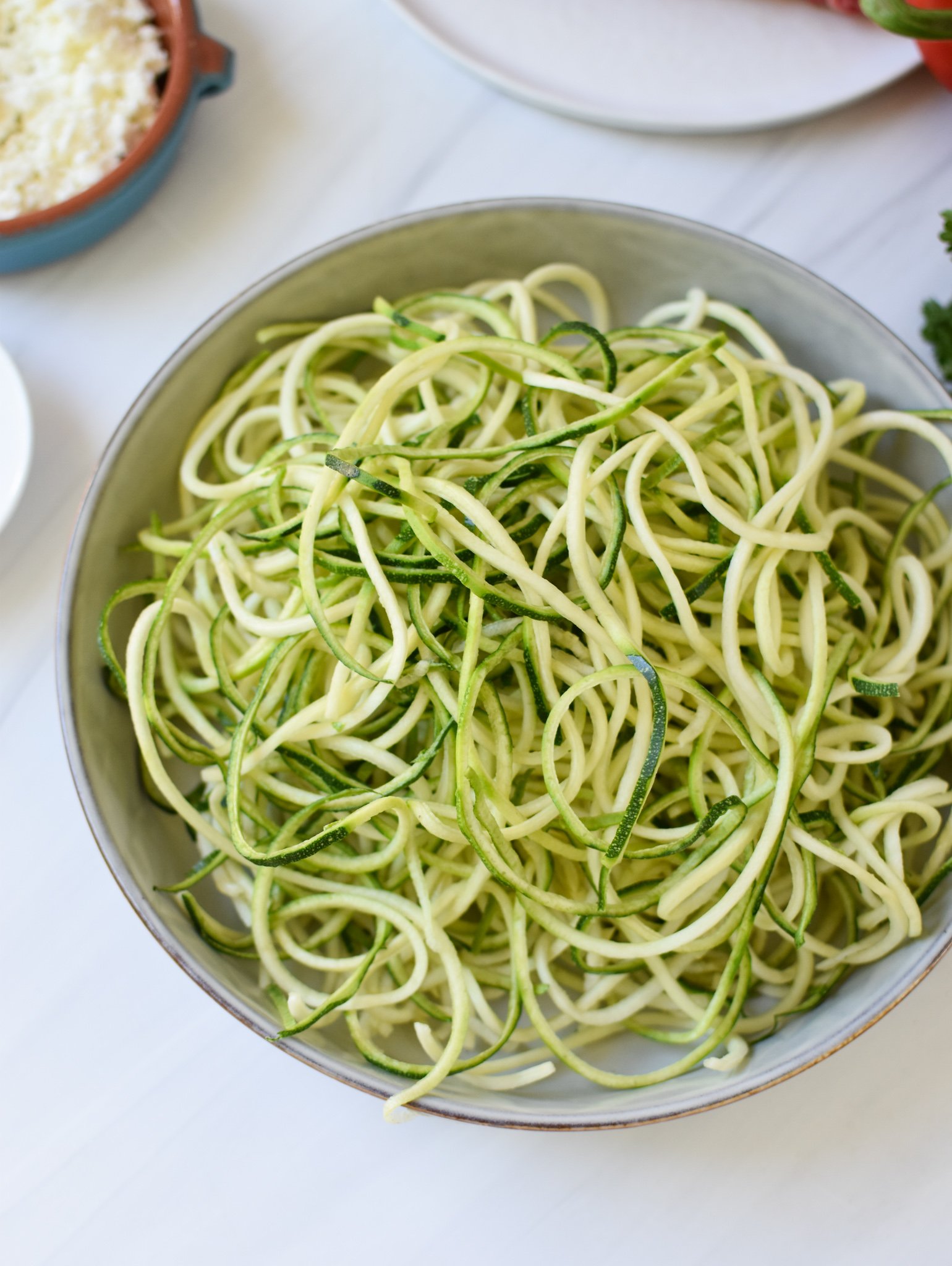 Mediterranean Ground Beef Zucchini Skillet zucchini noodles in a bowl. 