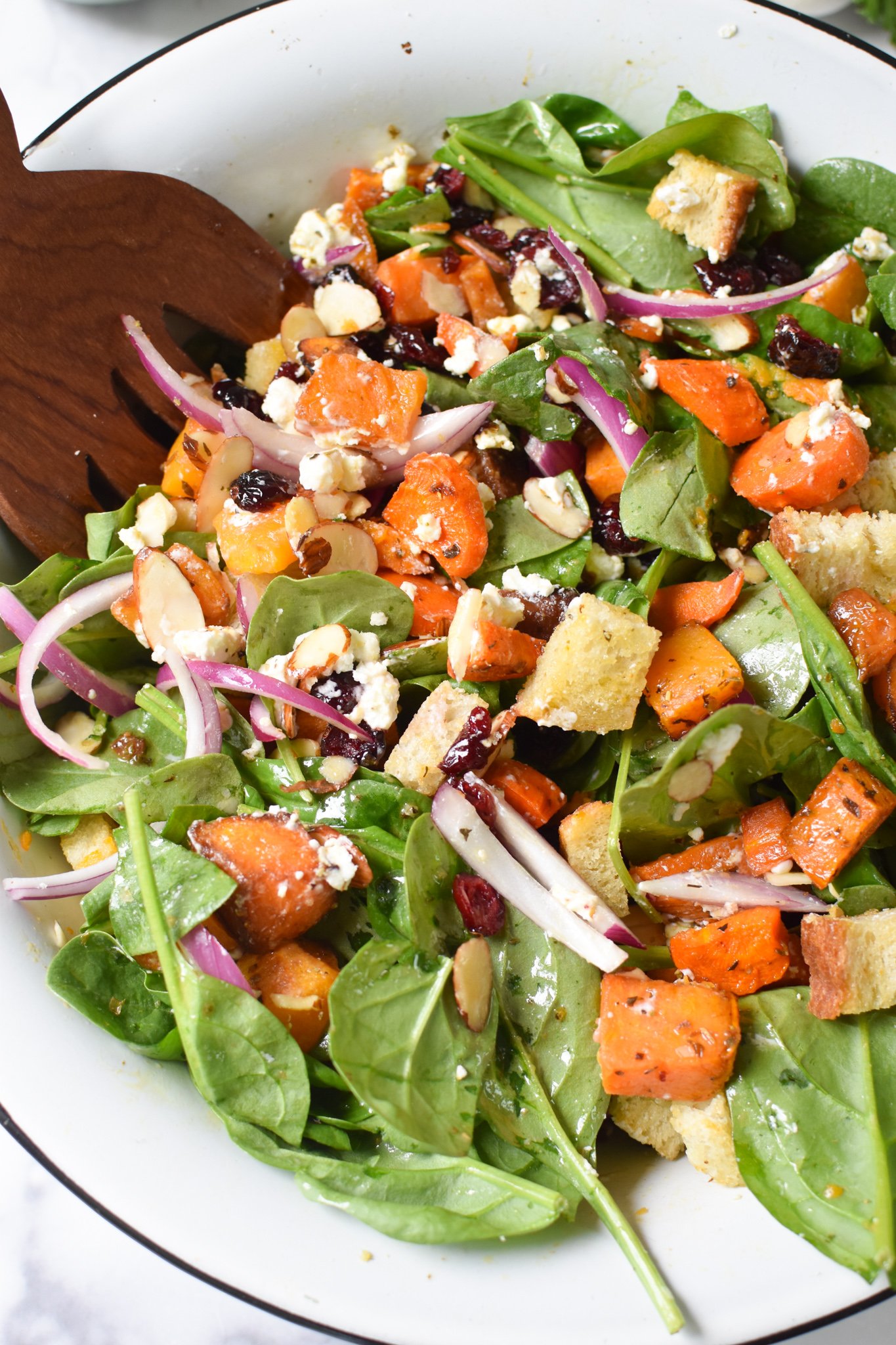 Roasted Vegetable Salad with wooden serving spoons.