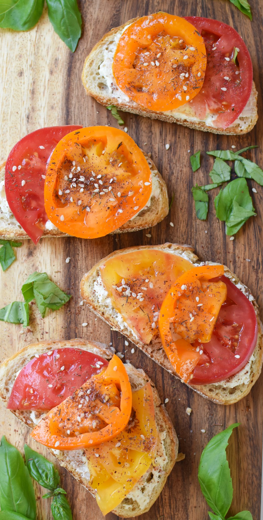 Tomato Toast with Whipped Feta toast on a cutting board. 