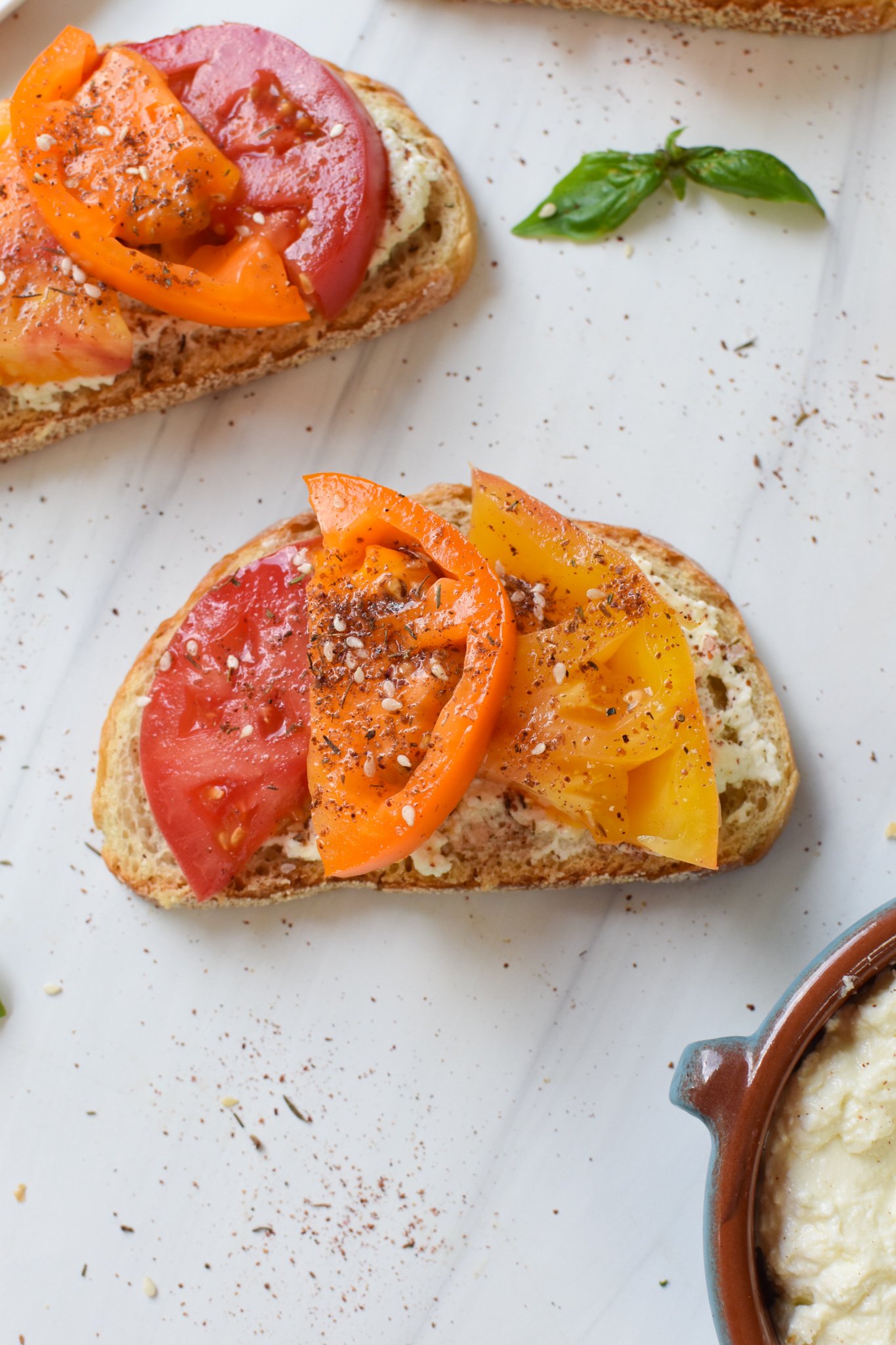 Tomato Toast with Whipped Feta with fresh basil.