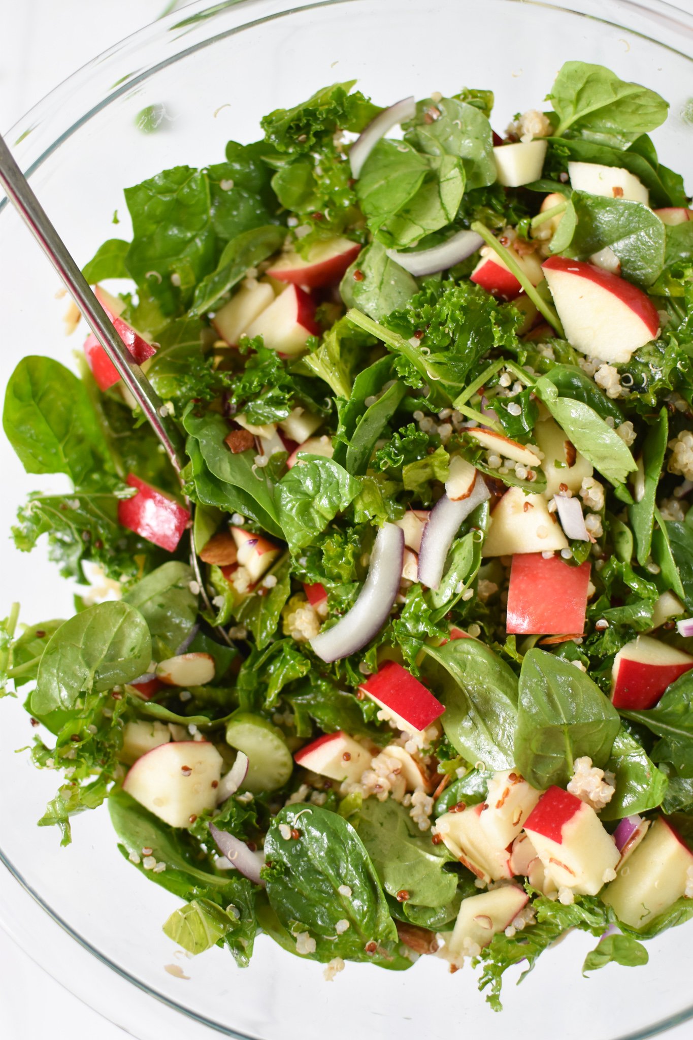 Apple Kale Quinoa Salad in a glass bowl.