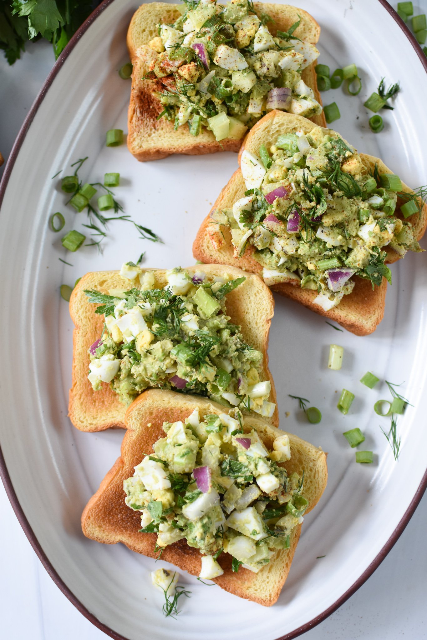 Avocado Egg Salad toast on a platter.