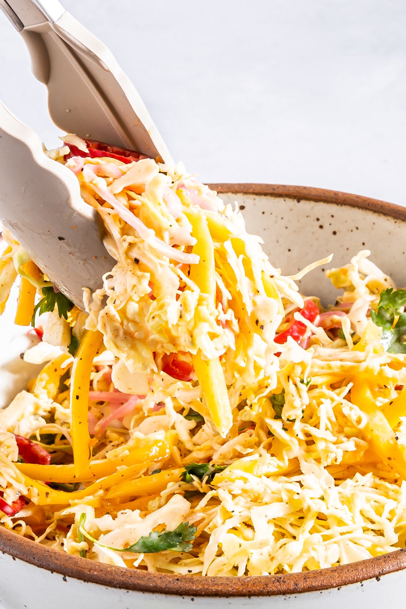Easy Caribbean Coleslaw Recipe with tongs