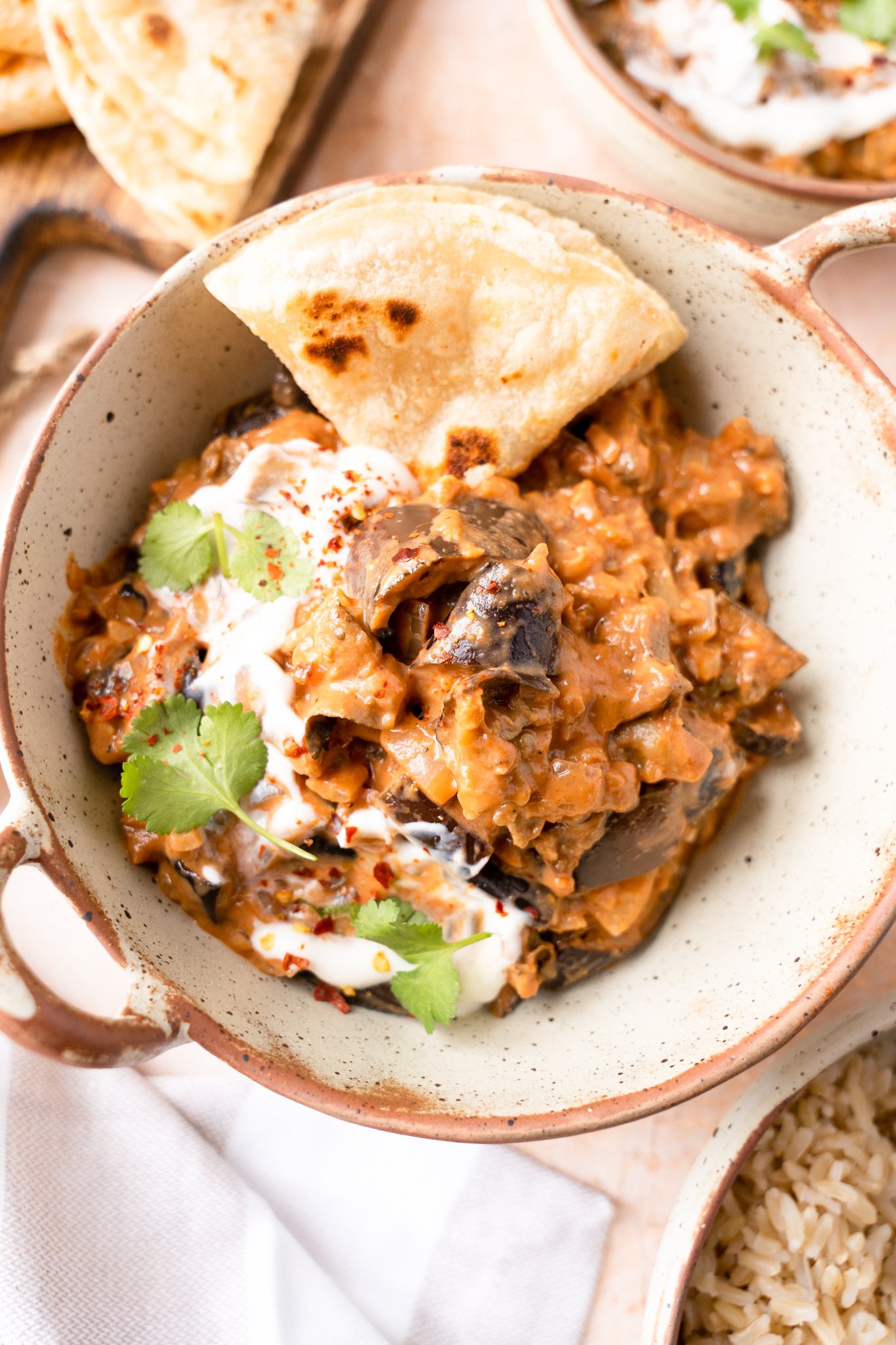 Easy Eggplant Curry with naan bread and cilantro.