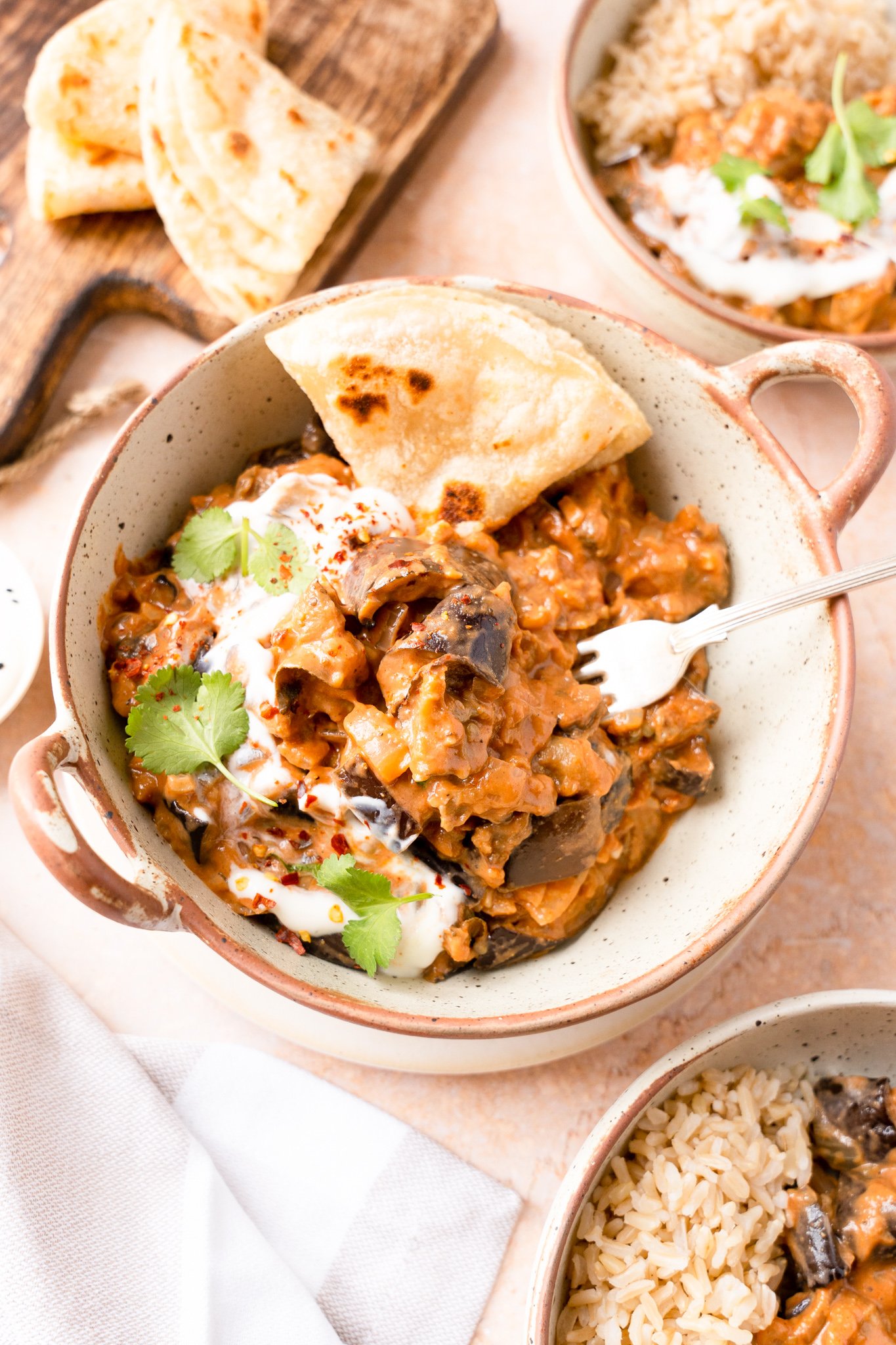 Easy Eggplant Curry in a white bowl with a fork.