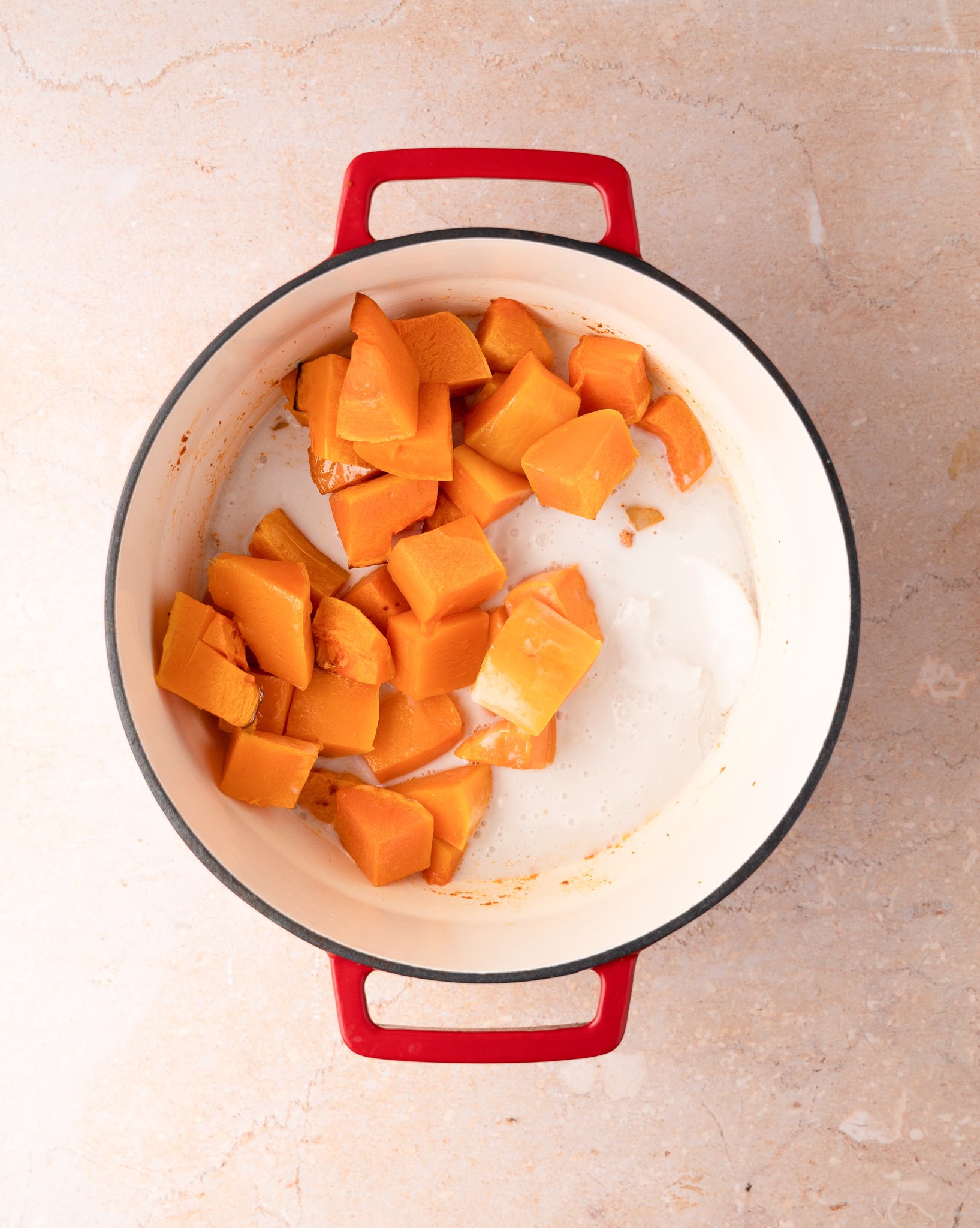 Thai Roasted Pumpkin Soup pumpkin and coconut milk in a pot. 