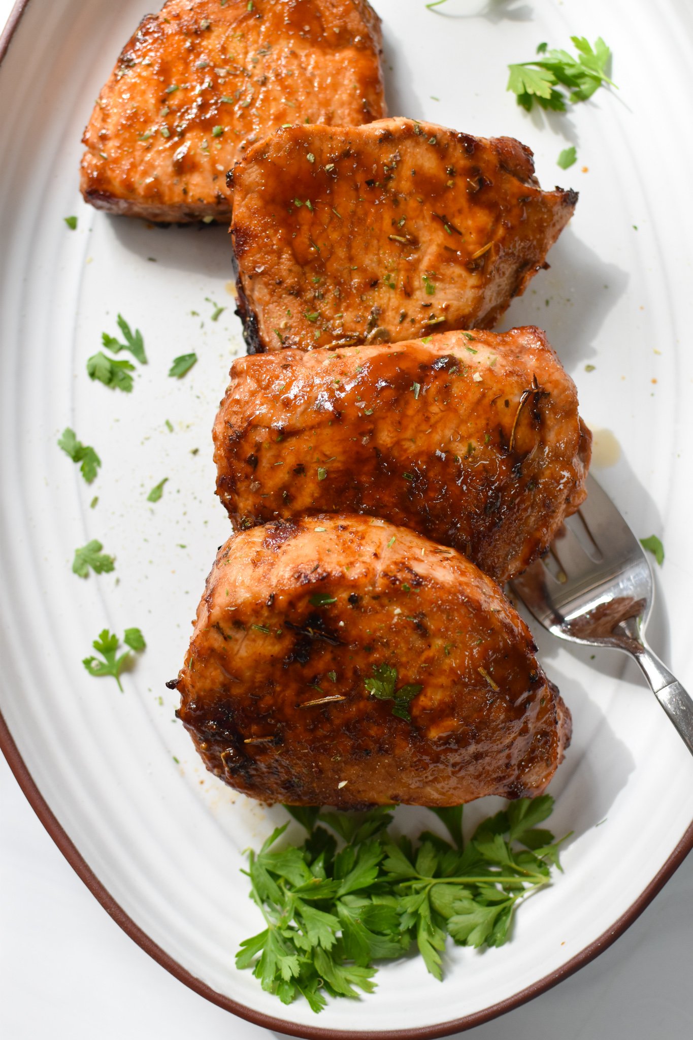 Air Fryer Boneless Pork Chops on a white plate. 