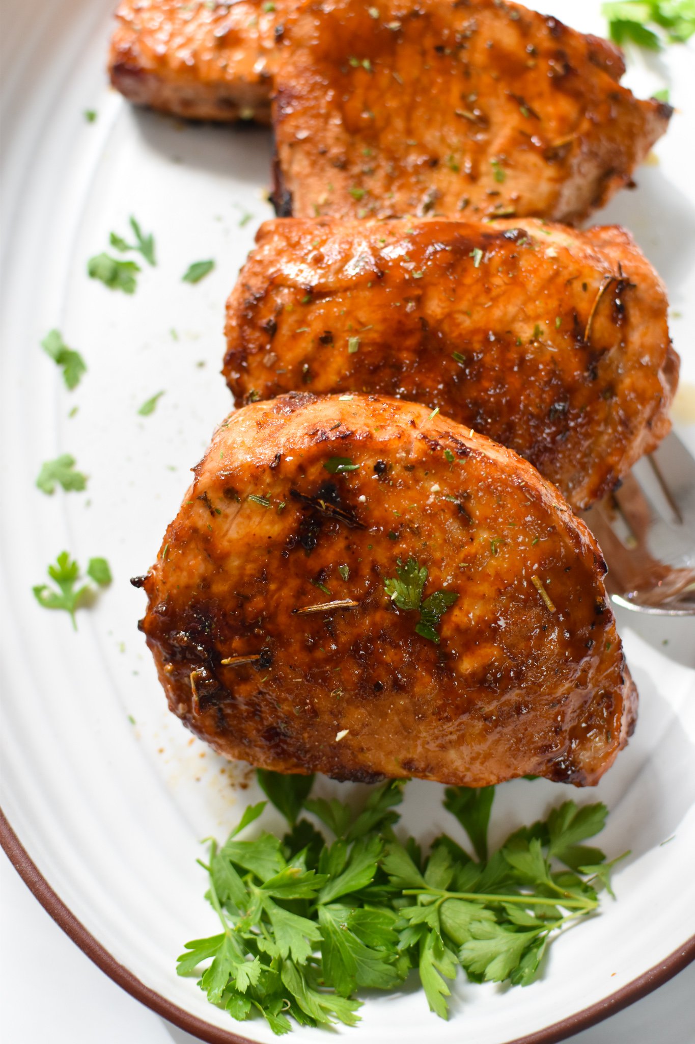 Air Fryer Boneless Pork Chops with white platter.