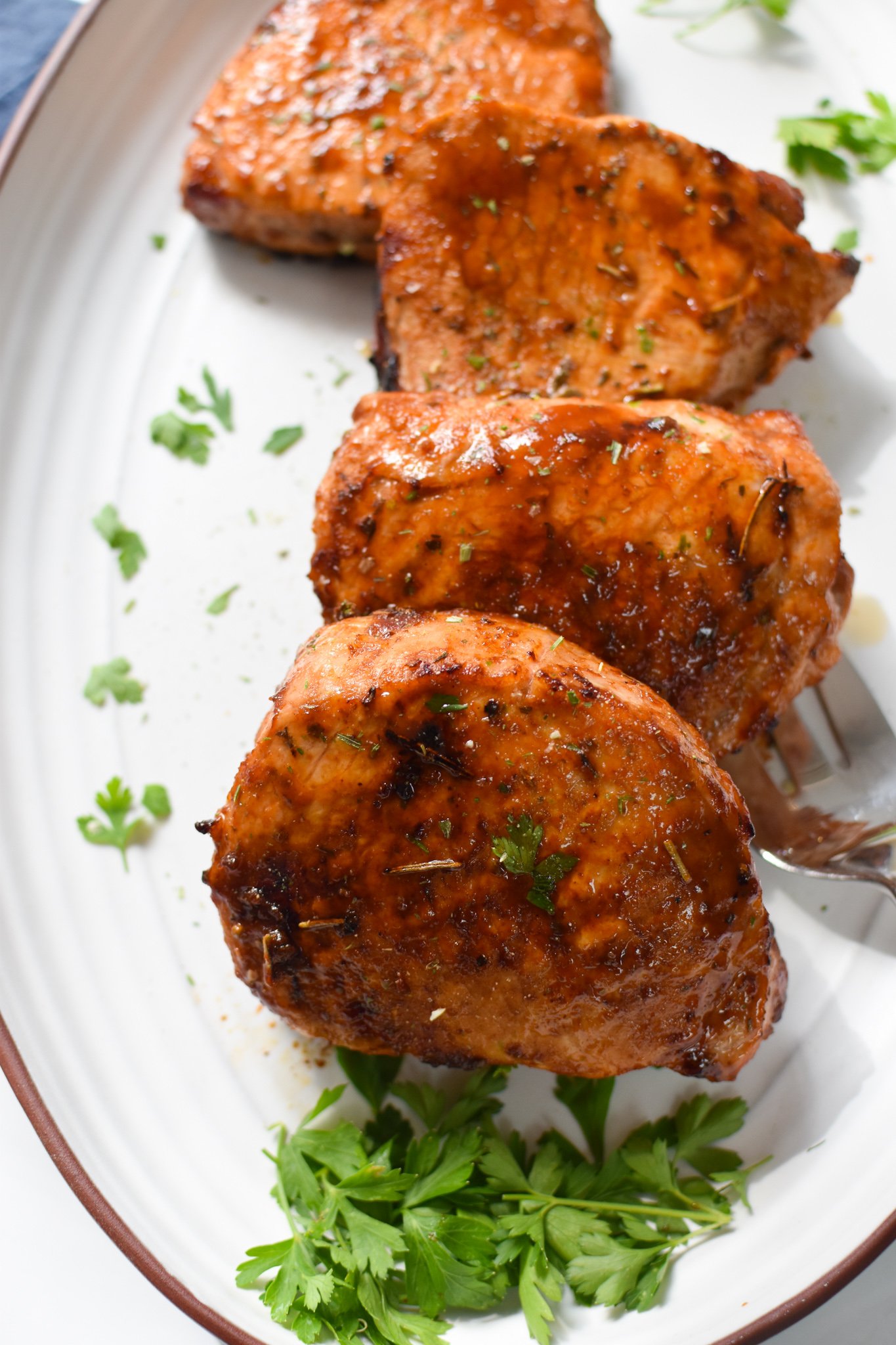 Air Fryer Boneless Pork Chops on a white plate. 