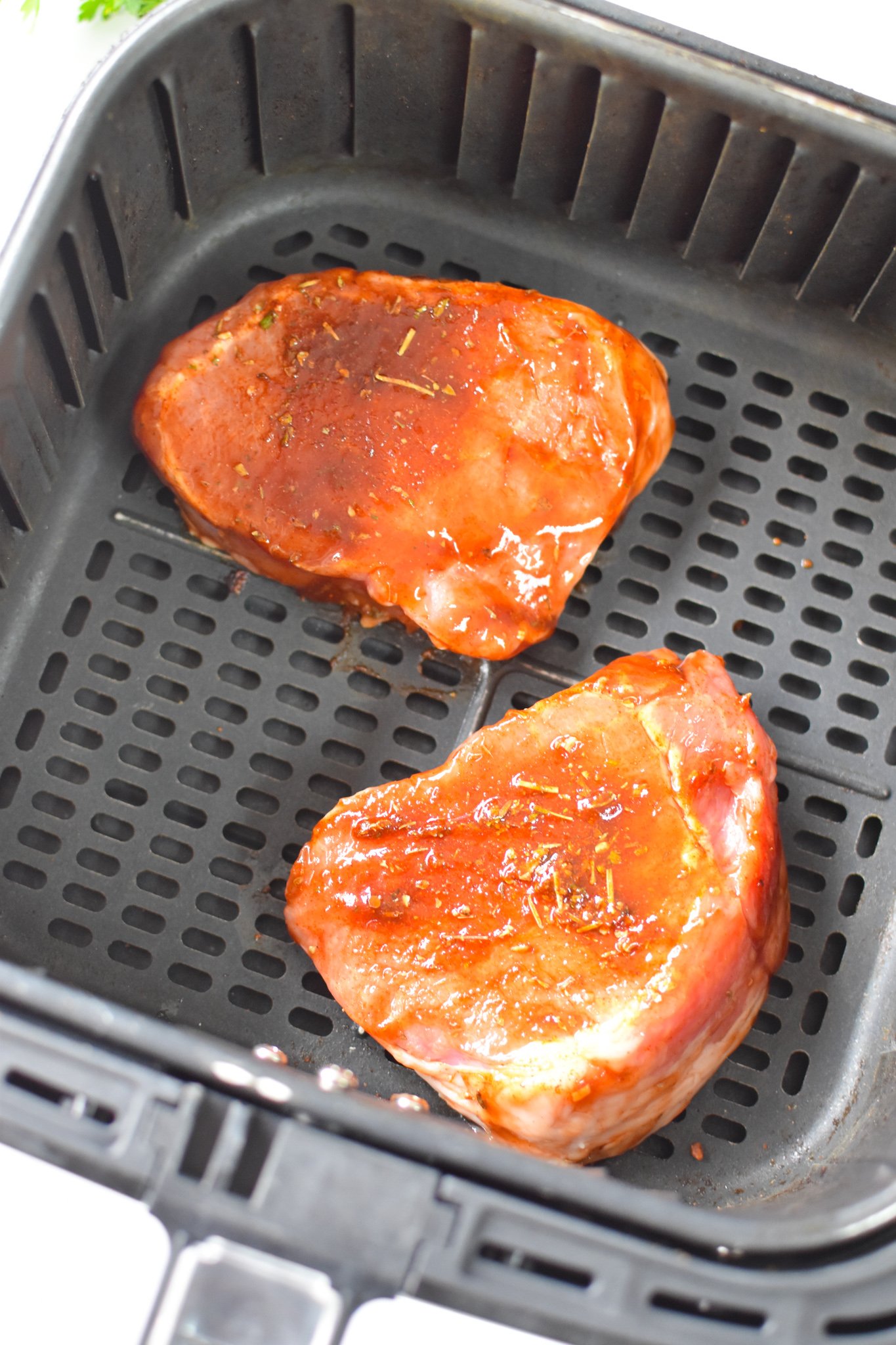 Air Fryer Boneless Pork Chops in the air fryer. 