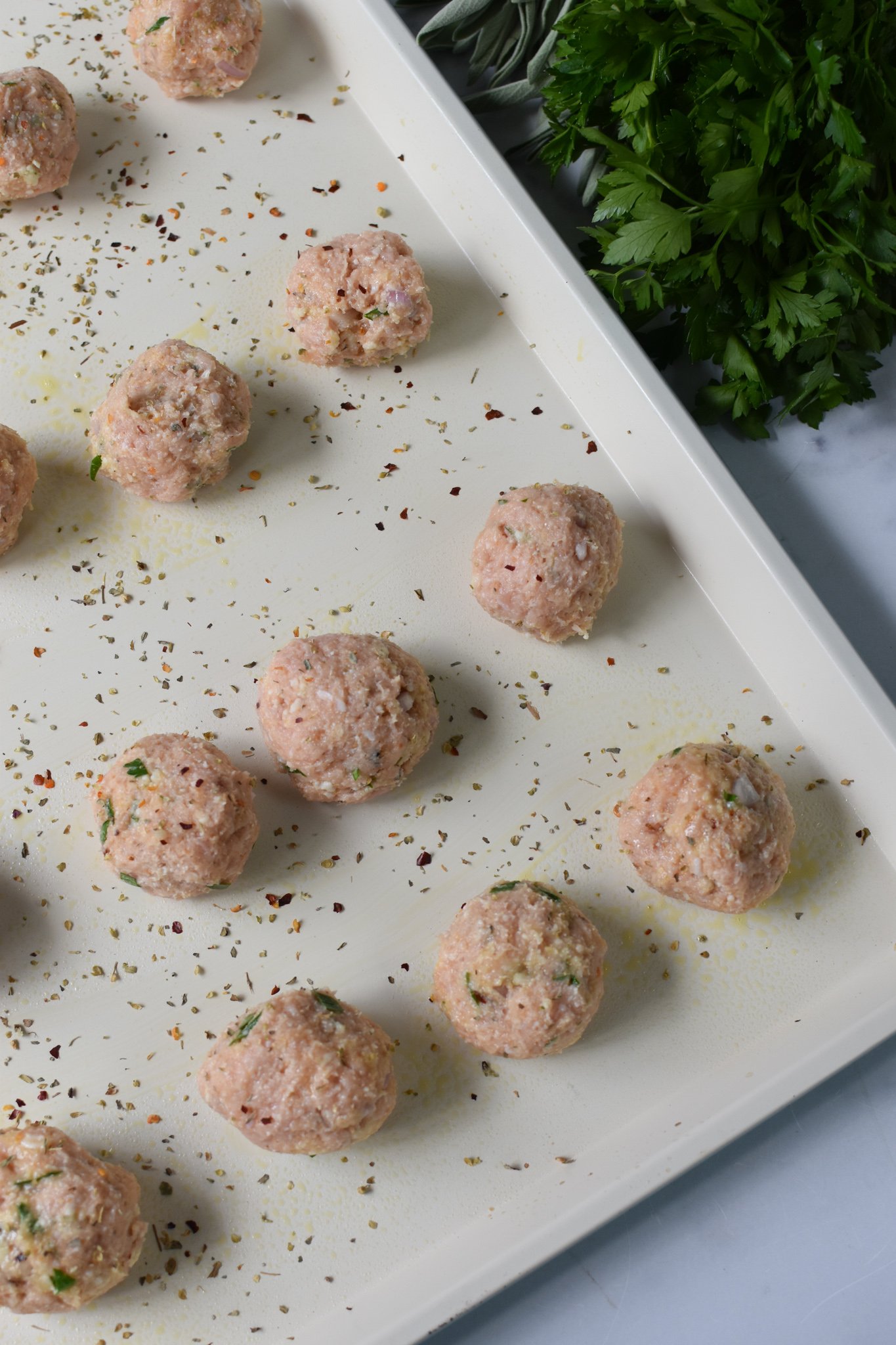 Baked Chicken Meatballs on a baking sheet. 
