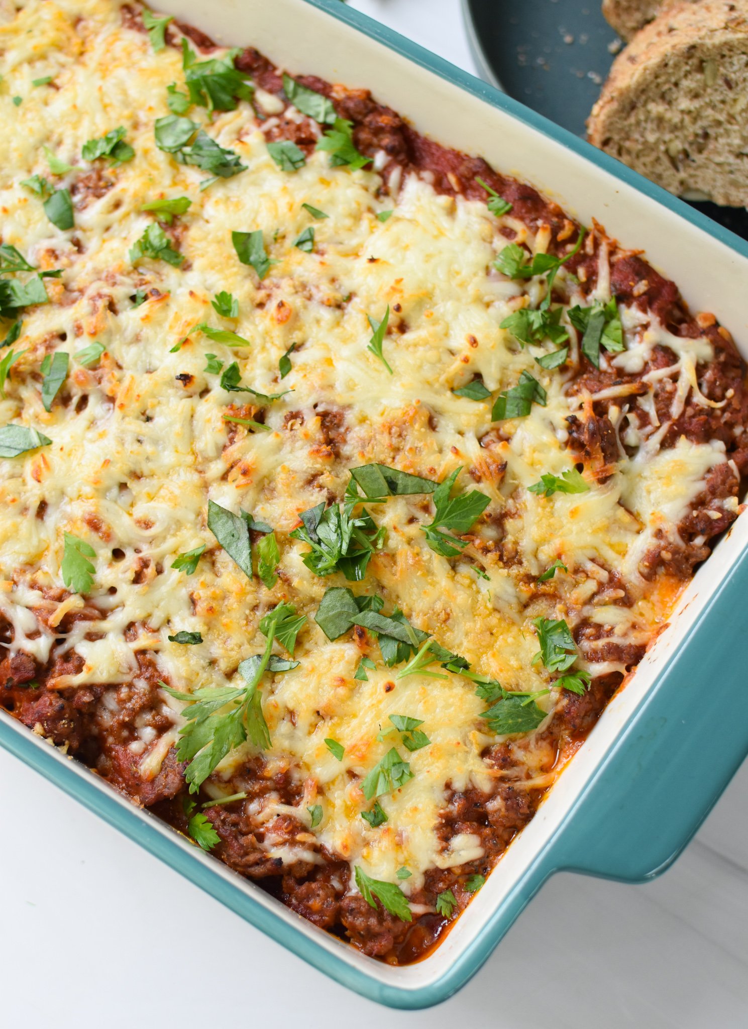  Spaghetti Pie Recipe in a teal dish. 