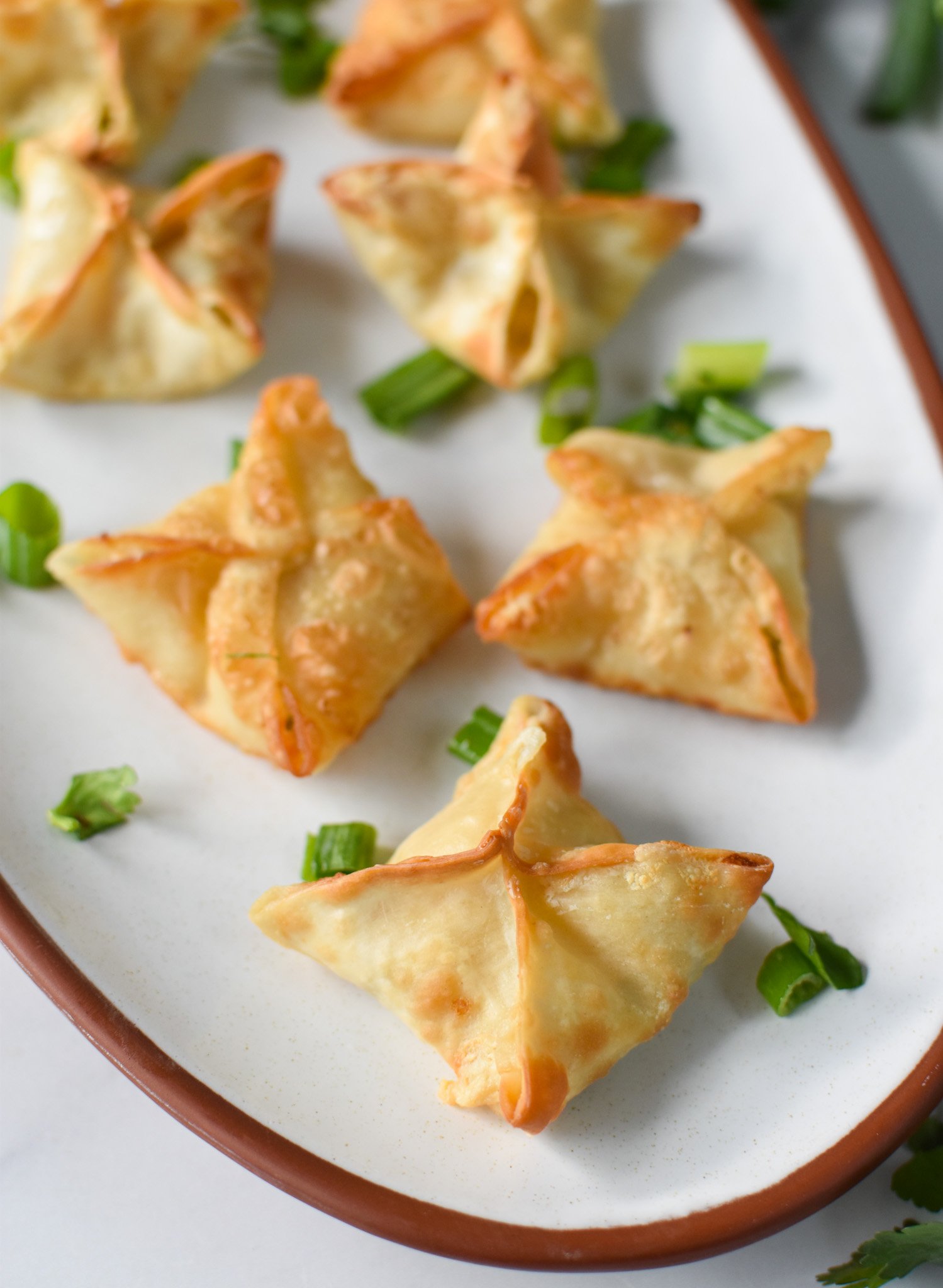 Air Fryer Crab Rangoon on a white platter. 