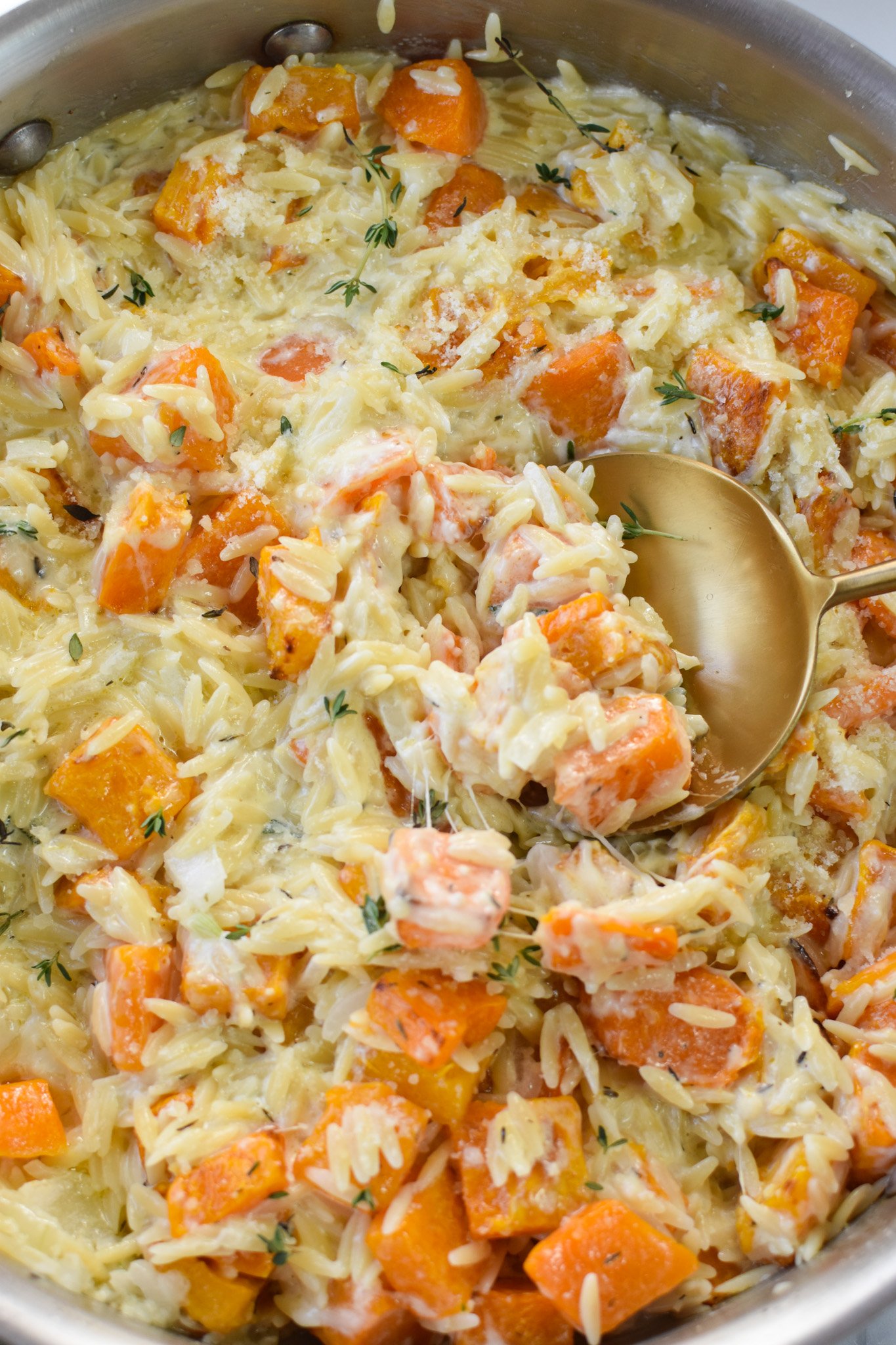 Cheesy Butternut Squash Orzo with gold spoon.