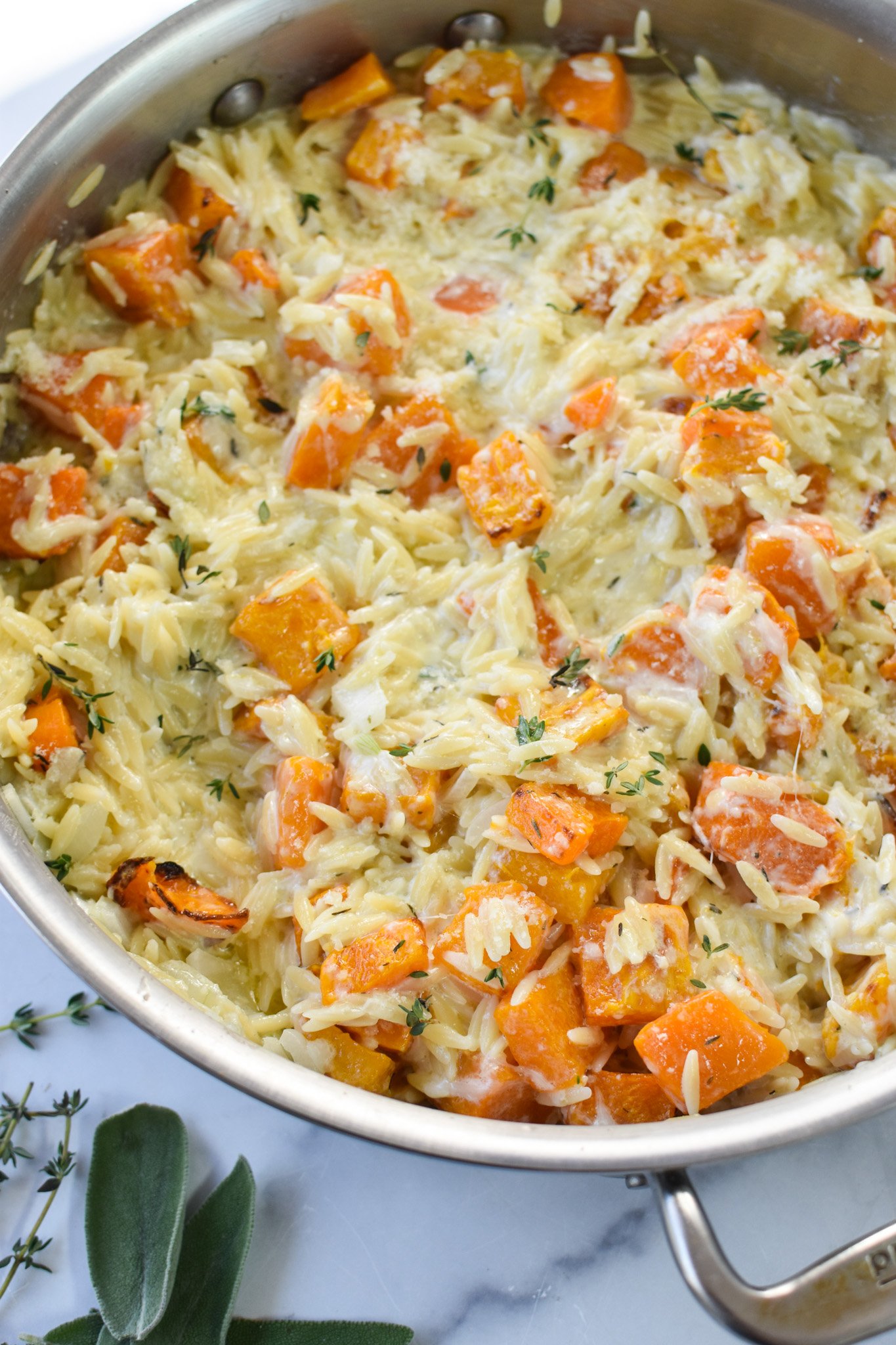 Cheesy Butternut Squash Orzo in a silver skillet.