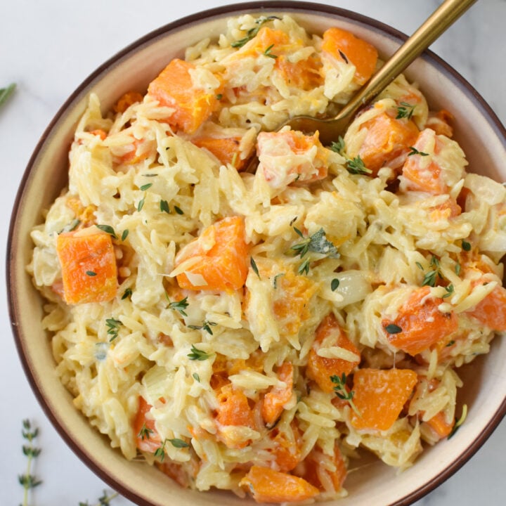 Cheesy Butternut Squash Orzo with a gold spoon.