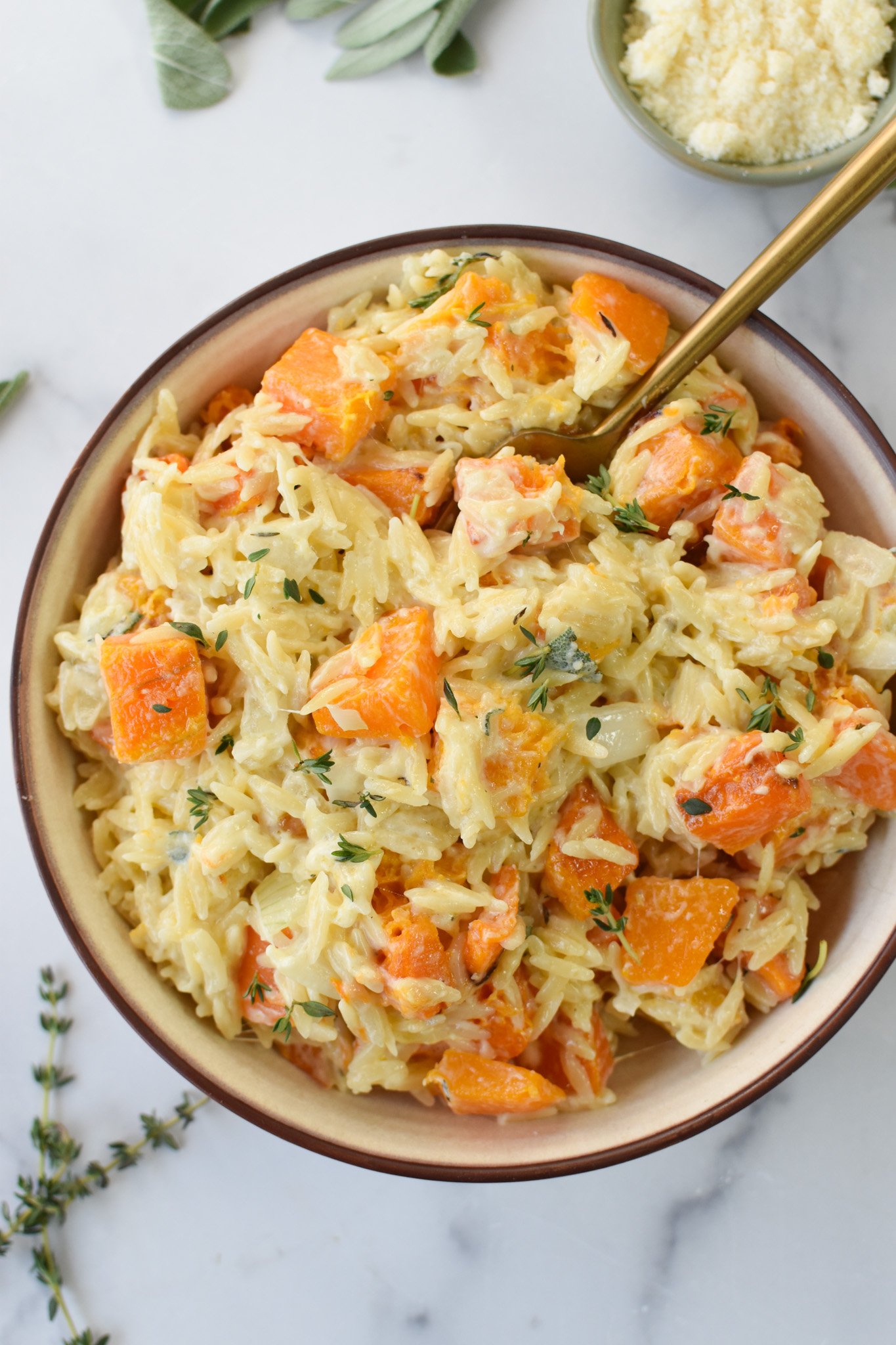 Cheesy Butternut Squash Orzo with a gold spoon.