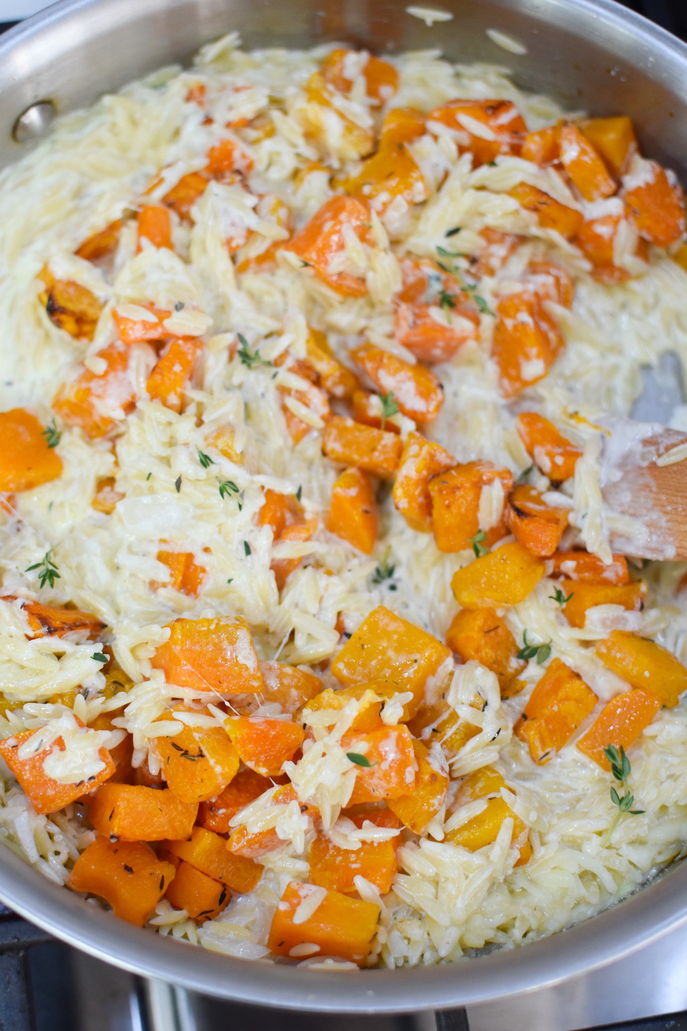 Cheesy Butternut Squash Orzo making the orzo in a pan. 