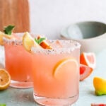 Grapefruit Paloma Cocktail with lemon wedges.