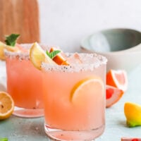Grapefruit Paloma Cocktail with lemon wedges.